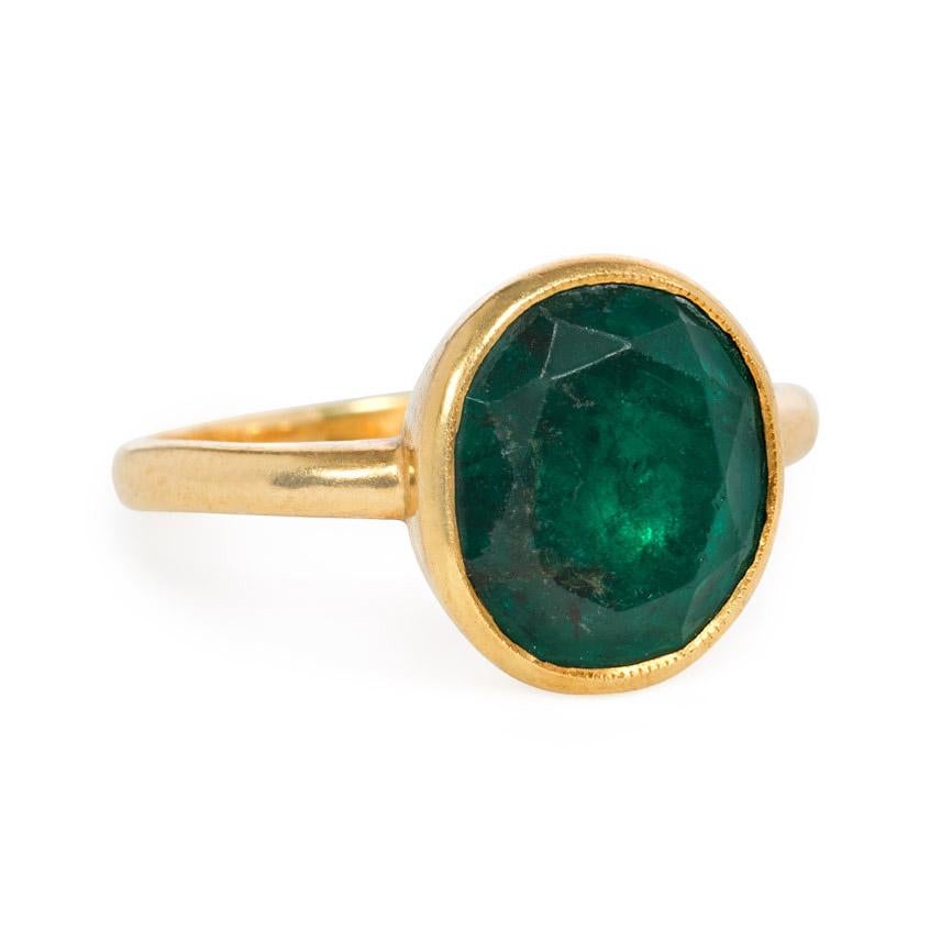 An antique single-stone emerald ring, the oval emerald in a closed back collet setting, in 18k.  Emerald measures approximately 11.5mm high x 10 1/3mm wide

Current size: US 7 1/4 (Please contact us with any re-sizing questions.)