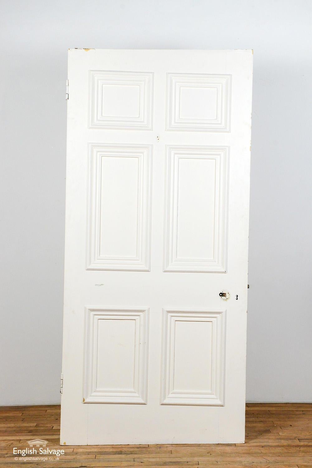 Reclaimed pitch pine Georgian door with six beaded panels. The door has a 2cm add on to the top and has been cut on a slant. Two hinges plus handle, lock and nail holes.