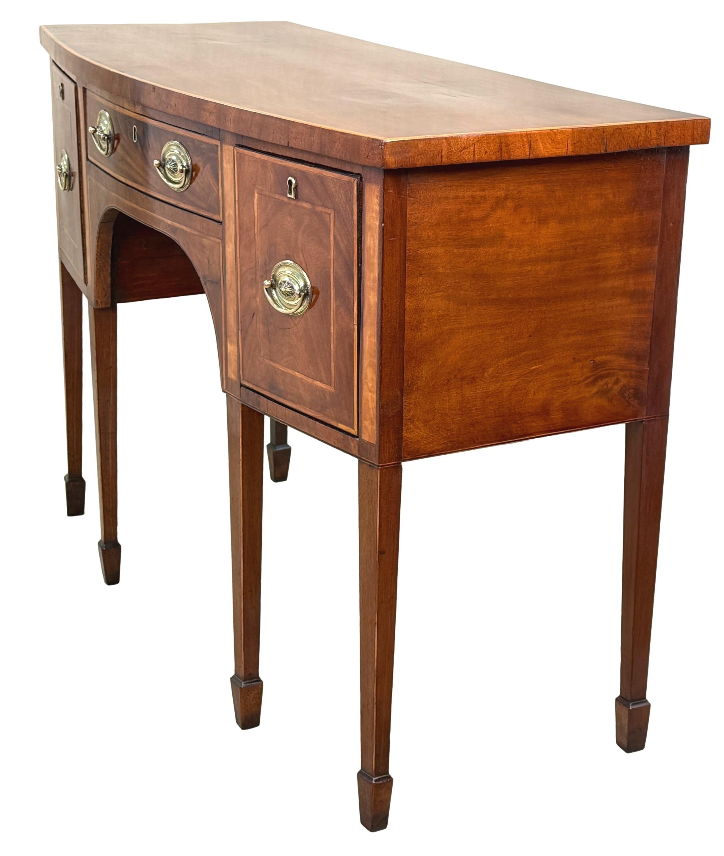 An Extremely Good Quality Late 18th Century, George III Period, Mahogany Bowfronted Sideboard, Of Elegant Relative Small Proportions, The Well Figured Top Over Three Drawers To Frieze, With Replacement Oval Plate Brass Handles And Fine Satinwood