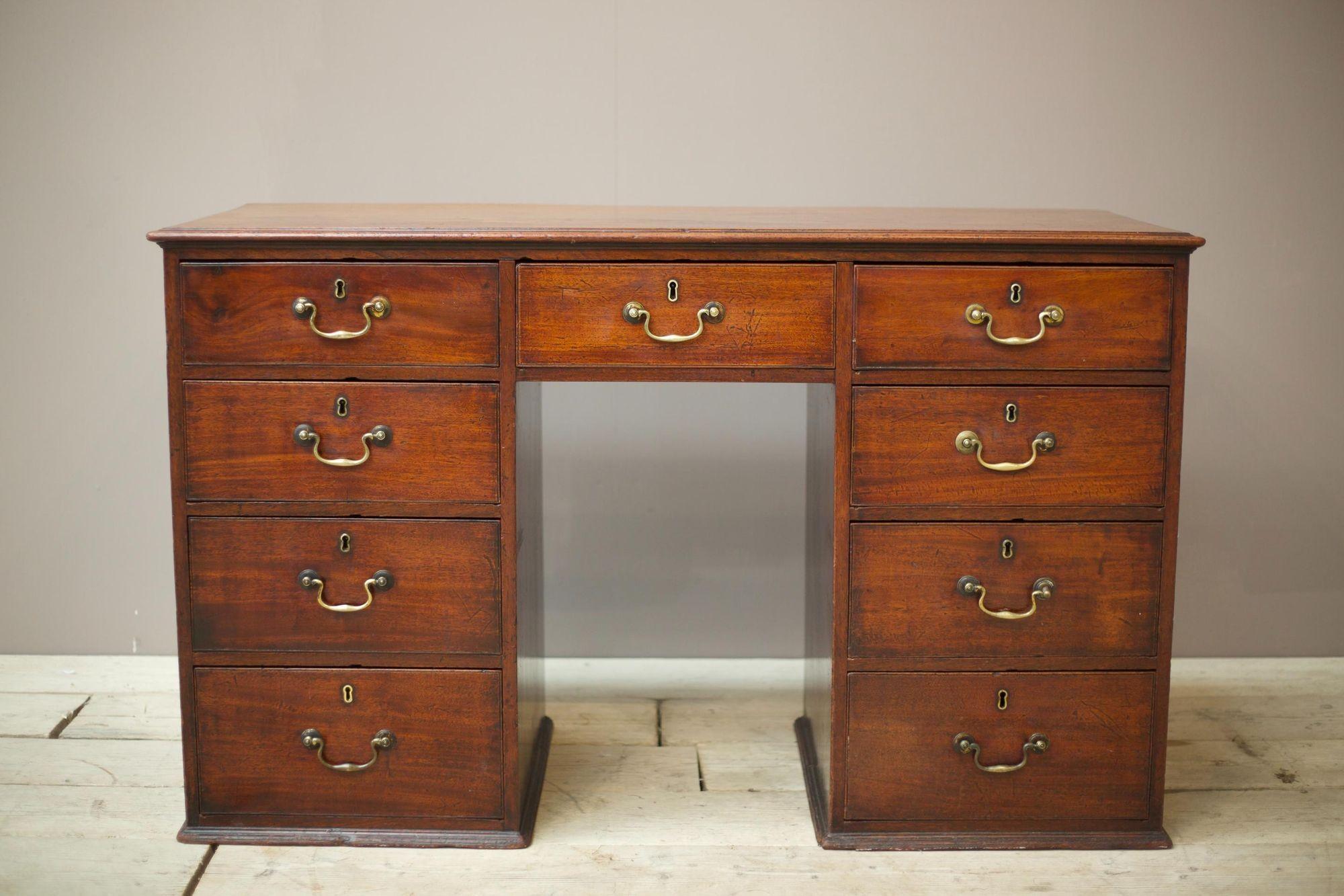 This is a simple very well made Georgian desk. Made from solid mahogany and as far as I can tell totally original. The drawers all run smooth and close flush. The overall condition is very good with attractive age related patina. Good sized desk as