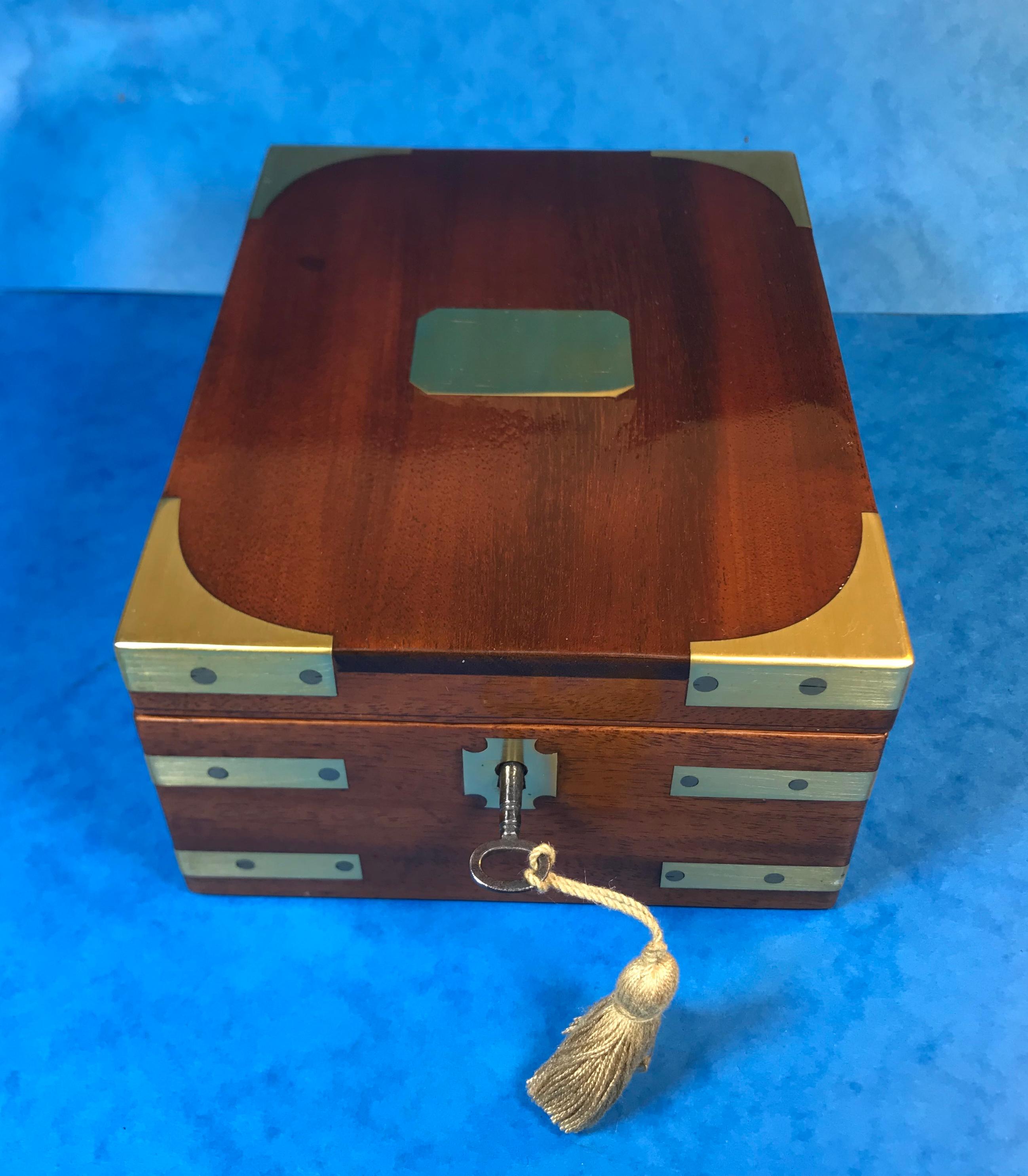 Georgian solid mahogany miniature campaign box.
A classic brassbound mahogany campaign box. Dating back to circa 1820 the box features a working lock and key and a interior that has been relined with hand crafted marble paper. The box is in superb
