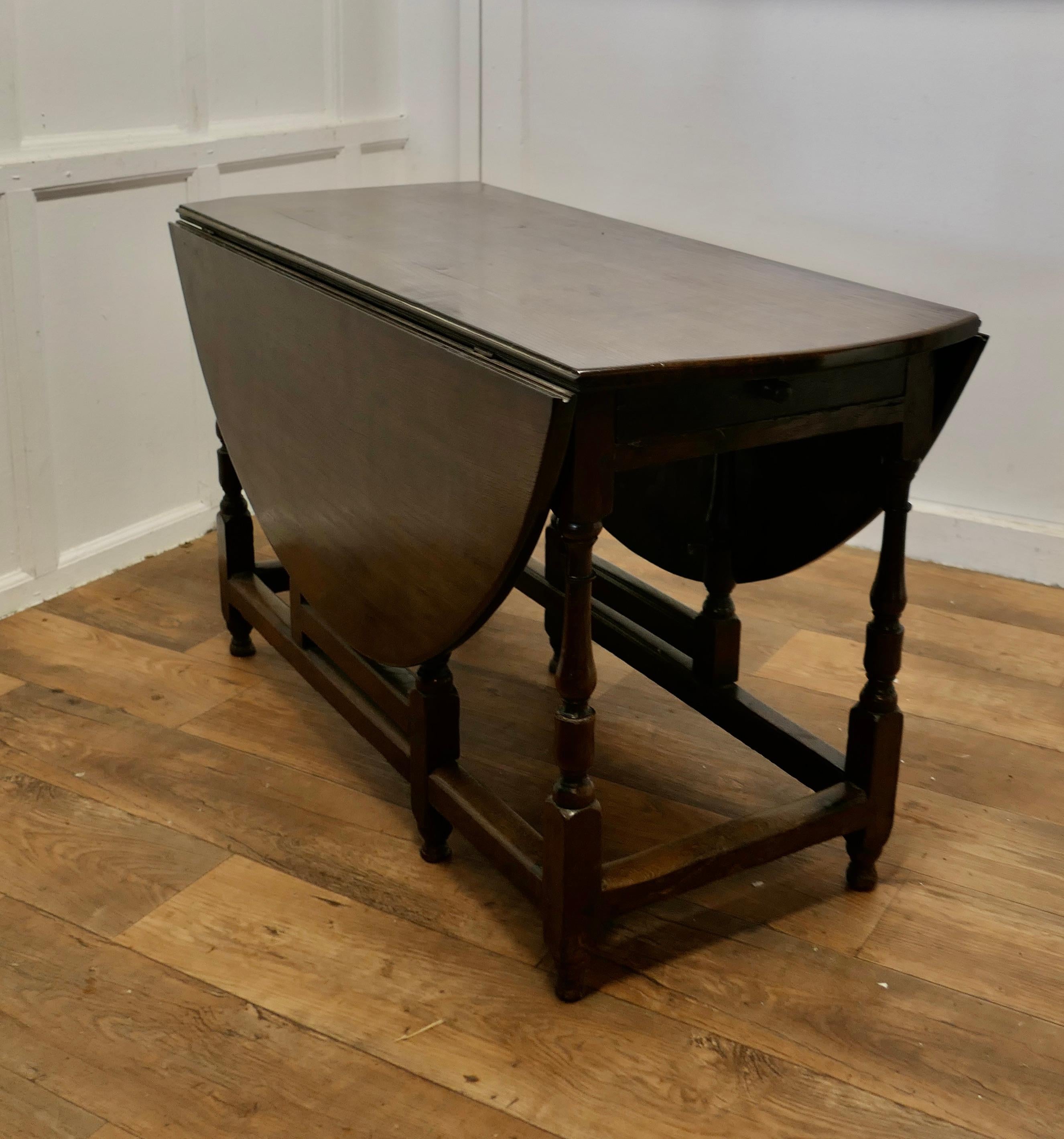 Georgian Solid Oak Gate Leg Dining Table

This is a Good Solid Oak Gate Leg Table, it is a large side and will seat 6 diners
The table is Oval and made from solid Oak it has elegant crisply turned legs and Oak cross members with a drawer at one end,