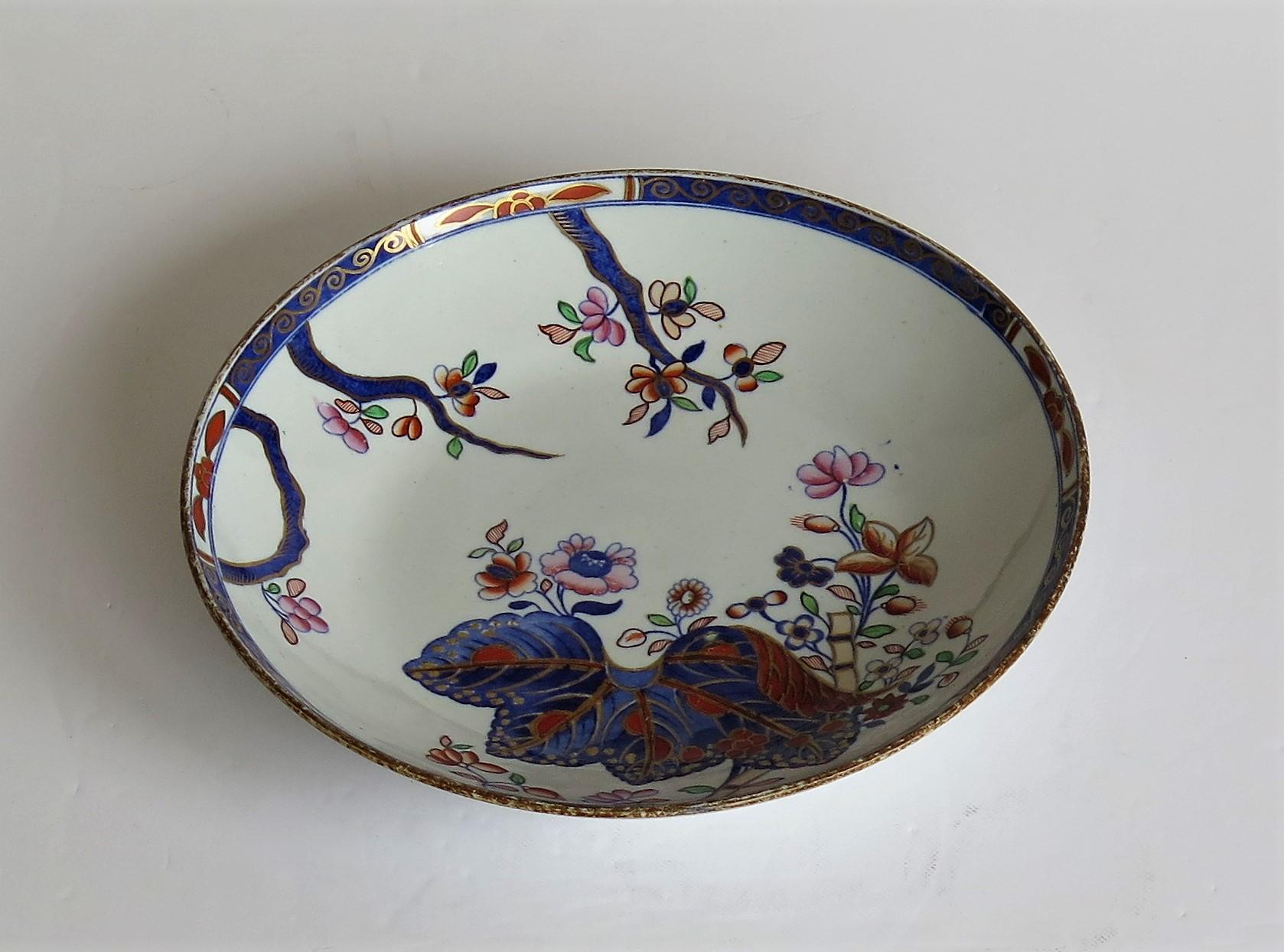 This is a very good porcelain deep plate or dish, hand painted in the tobacco leaf pattern, number 2061, made by the Spode factory, in the early 19th century, English Georgian period, circa 1810.

The dish is well potted on a low foot and