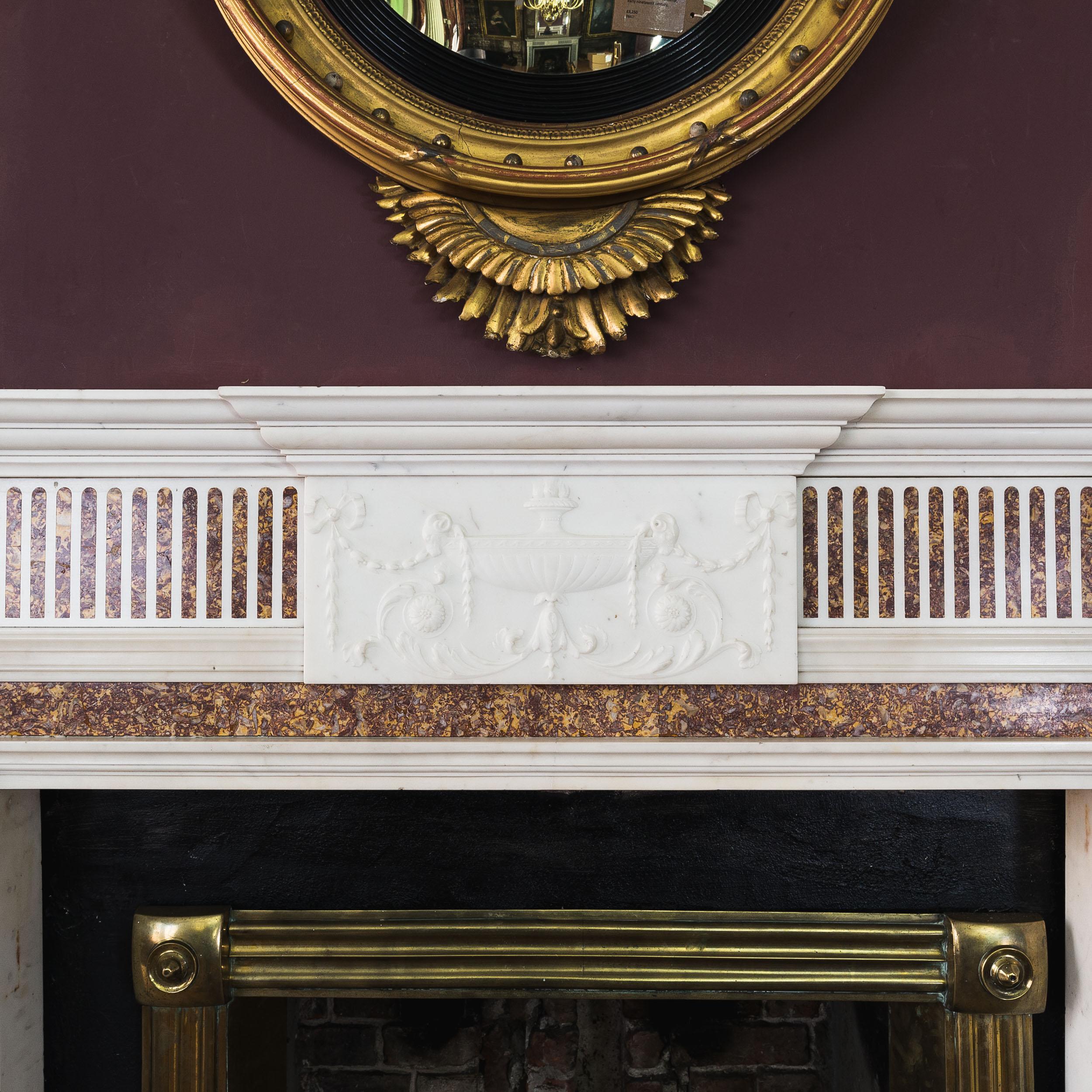 Elegant late Georgian Statuary marble chimneypiece with Spanish Brocatello inlay, c.1790, the breakfront, moulded shelf above central tablet carved with classical tazza and strings of bellflowers, the corner-blocks again depicting lidded urns hung