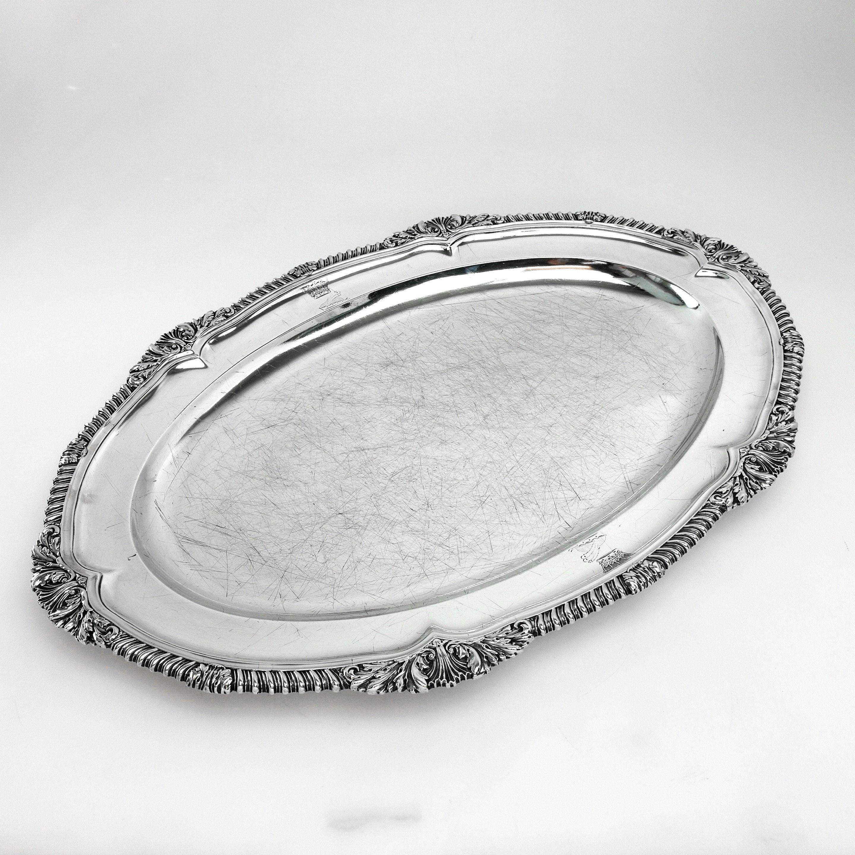 A Classic Georgian sterling silver Meat Dish serving platter. This Meat Platter is of substantial size and has a Classic oval shape. The Meat Platter has an ornate shell and gadroon border embellishing the rim. The Dish has two matched crests