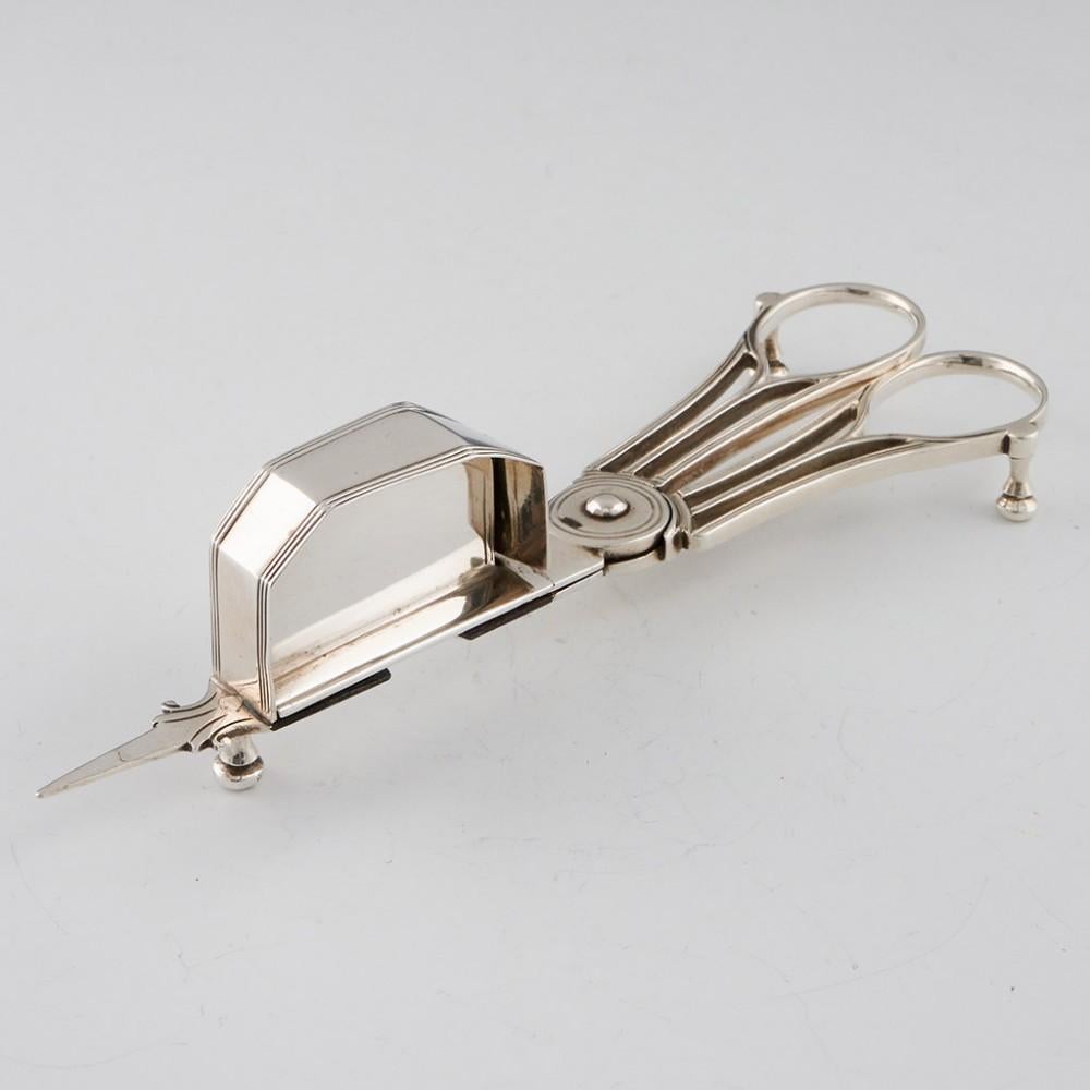 Georgian Sterling Silver Candle Wick Trimmer or Snuffer London, 1791

Prior to the mid 19th century the tallow (animal fat) or wax of a candle burned faster than the wick. To promote a steady flame, the wick needed to be trimmed. These are intended