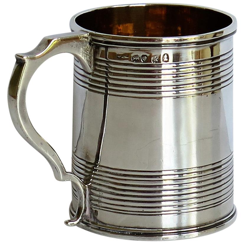 This is a very good, sterling silver mug or Christening Mug made in the late Georgian, George IVth Regency period, by Joseph Angell 1st of London, in 1825.

The mug is handmade and has a slightly tapered body with a notched loop handle. It has