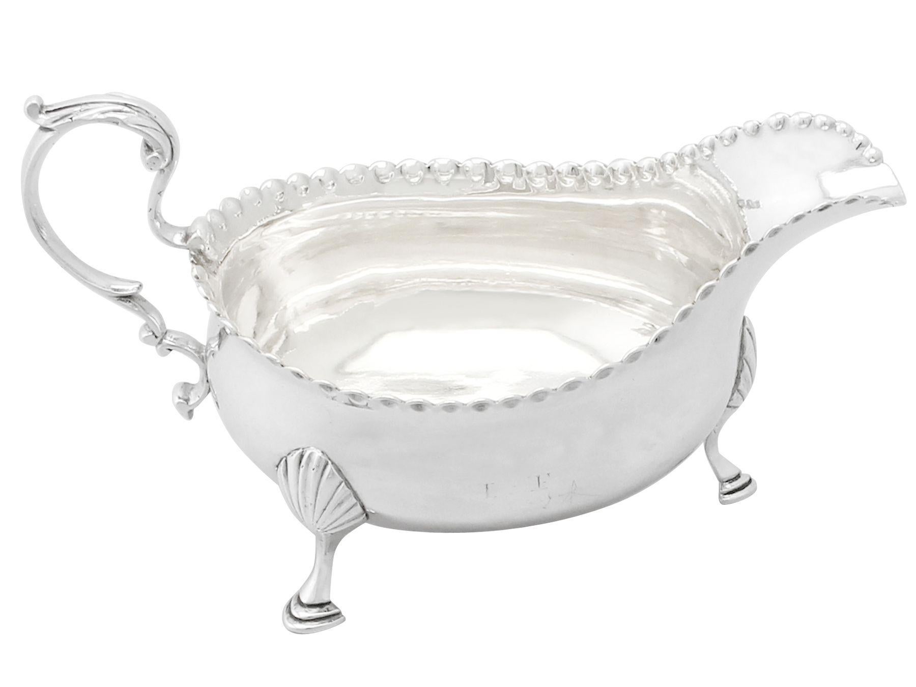 A fine and impressive antique Georgian Newcastle sterling silver sauce boat made by John Langlands I & John Robertson I; an addition to our silver dining collection.

This exceptional antique George III sterling silver gravy boat has a plain oval