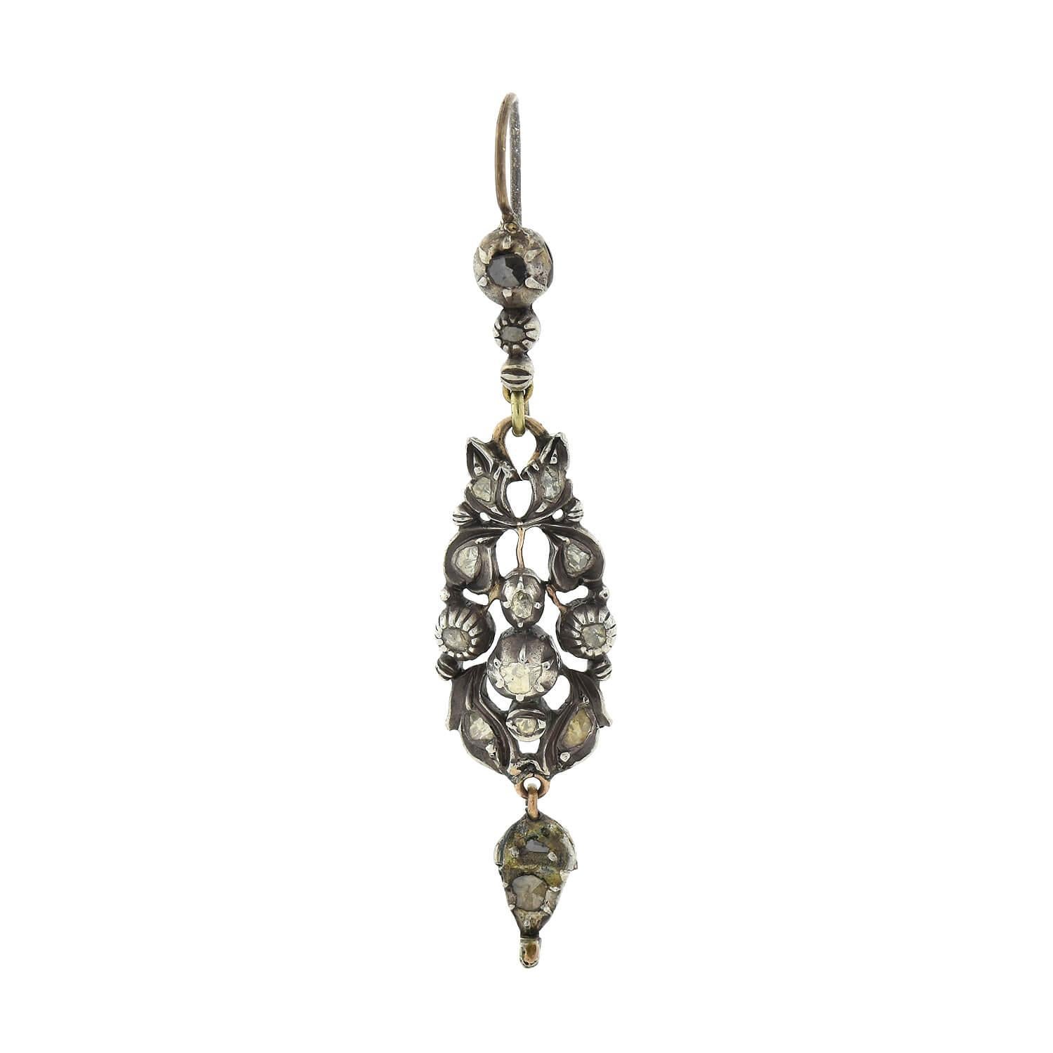 A magnificent pair of earrings from the Georgian (ca1750s) era! Crafted in sterling silver, these earrings begin with a simple earring wire atop three graduated round settings, the top two adorning glinting Rose Cut diamonds in faux collet settings.