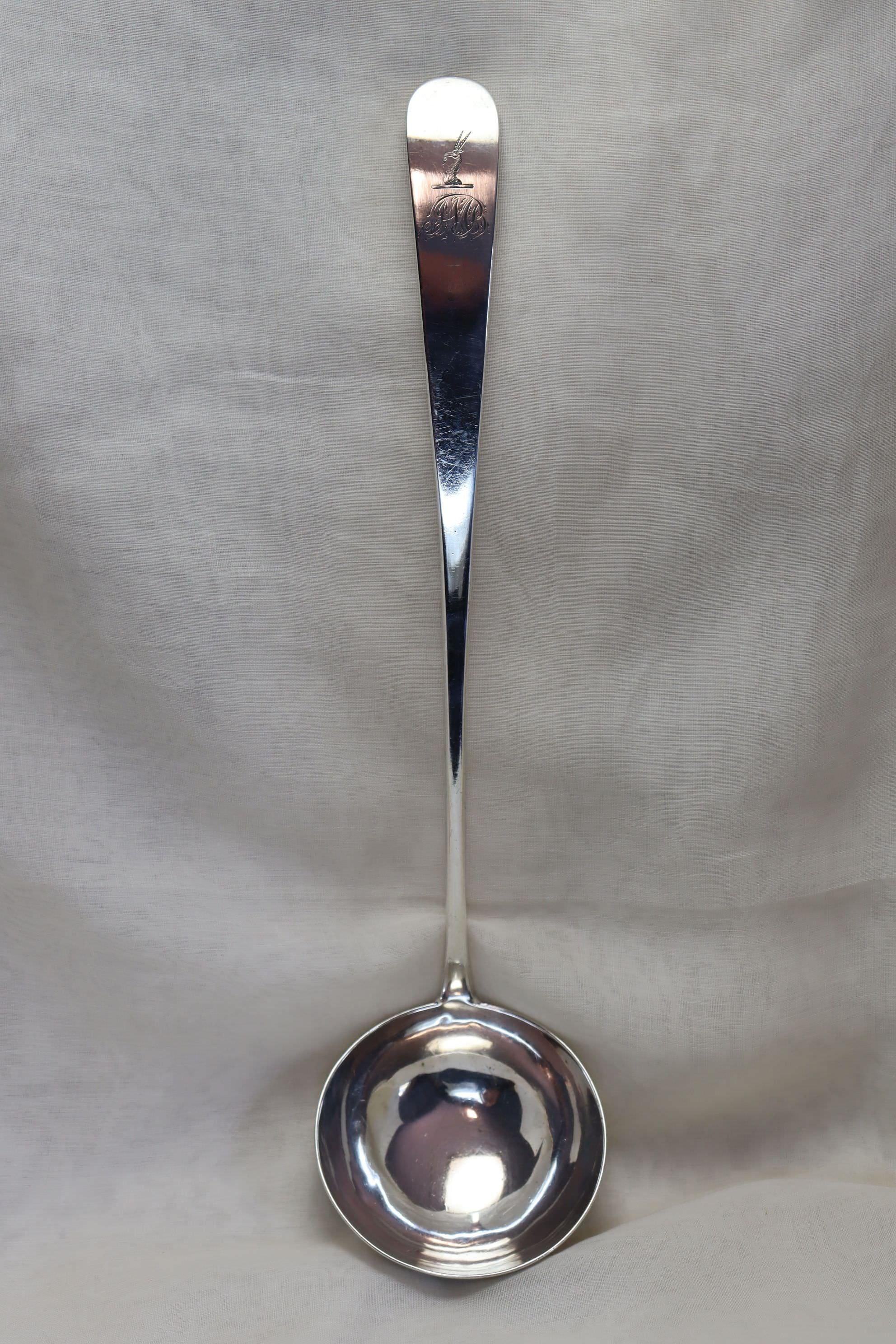 This large Georgian sterling silver soup ladle carries the makers mark for Graham and McLean of Glasgow and was assayed in Edinburgh in 1801. The long elegantly curved handle also carries a family crest, possibly Scottish, and the monogram I (or J)