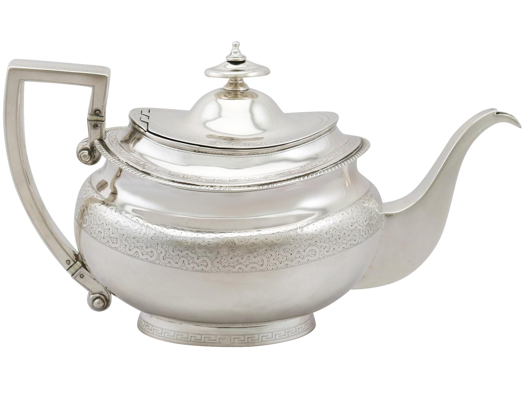 A fine antique Georgian English sterling silver three piece tea service with matching teapot stand / set; part of our silver teaware collection.

The pieces of this George III sterling silver three piece tea service with matching teapot stand have
