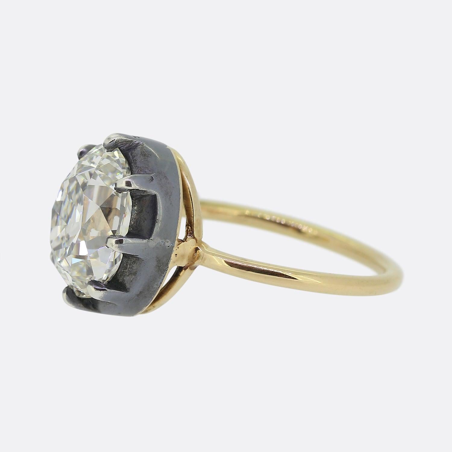 Here we have a marvellous Georgian style diamond solitaire ring. Set upon a thin 18ct yellow gold band, the face of the piece presents a single oval faceted old cut diamond which has been set in a silver cut collet setting with a wide exposed