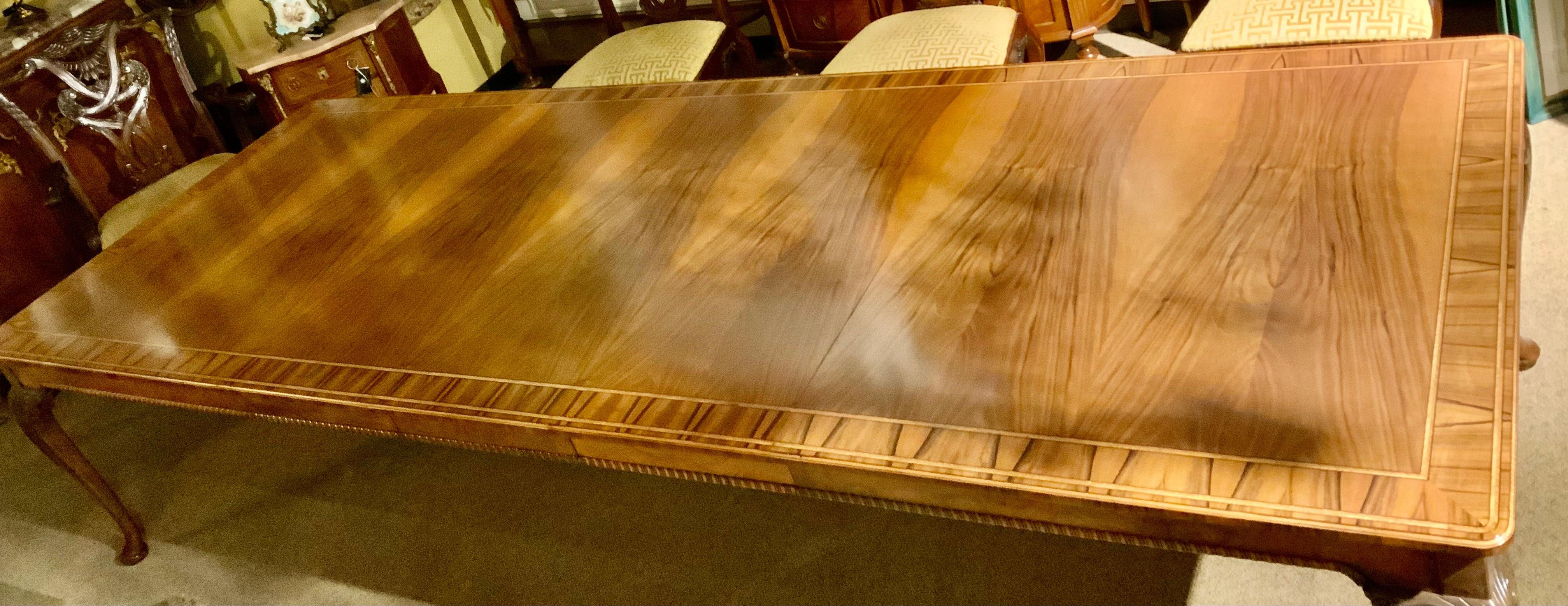 The top is book-matched veneers and has a banded edge
Raised on cabriole legs with acanthine-carved knees ending in 
Pad Feet. The color is a honey hue with original finish and patina. It has three leaves which measure 17.5 inches each. The