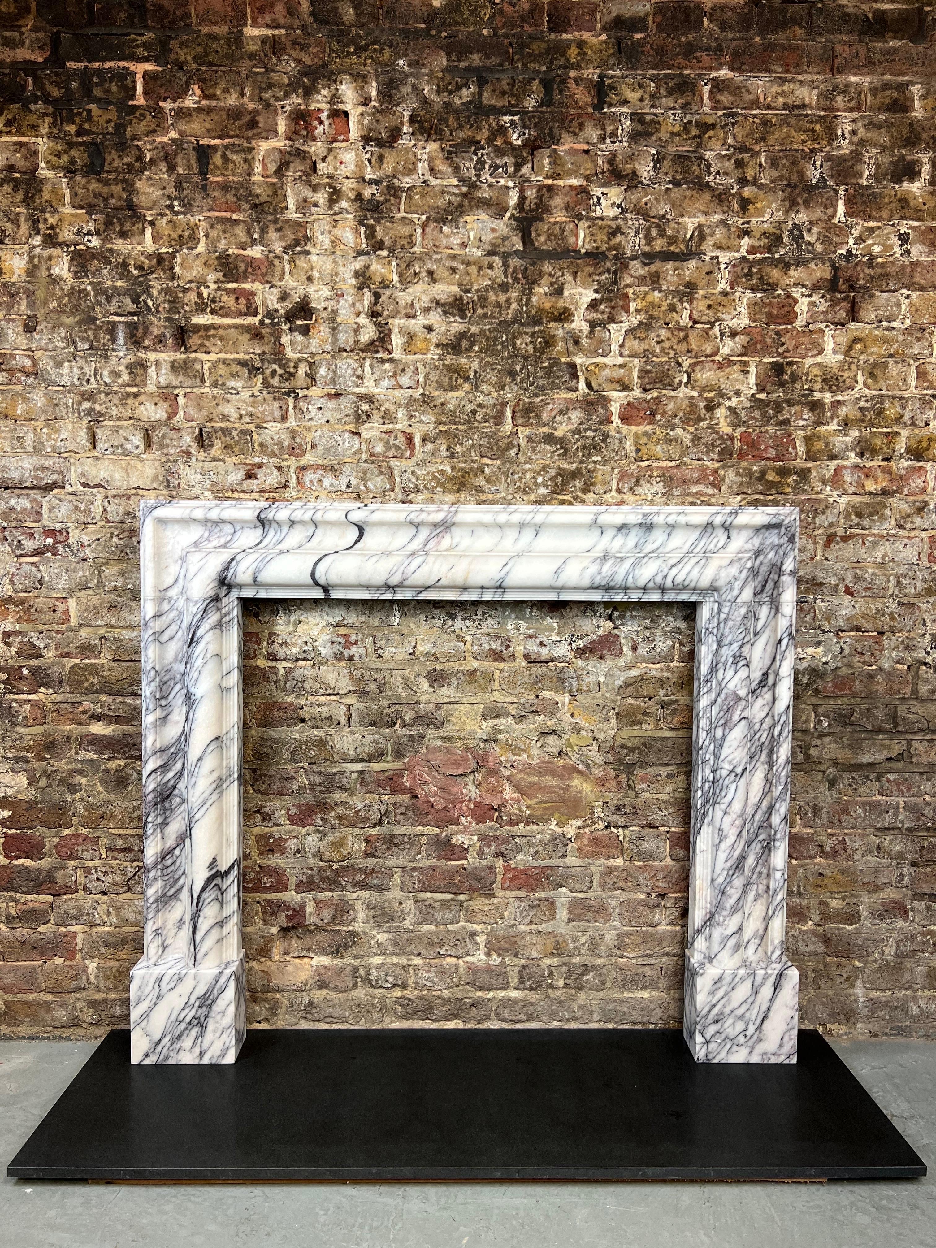 Georgian Style Bolection marble fireplace mantlepiece.
Made From BeautifuI Antique Italian Breche Viola Marble. 
A Bolection Moulding Design Derived From the Queen Anne Period 1702 - 1714, However This Style Also Ran Throughtout The Georgian