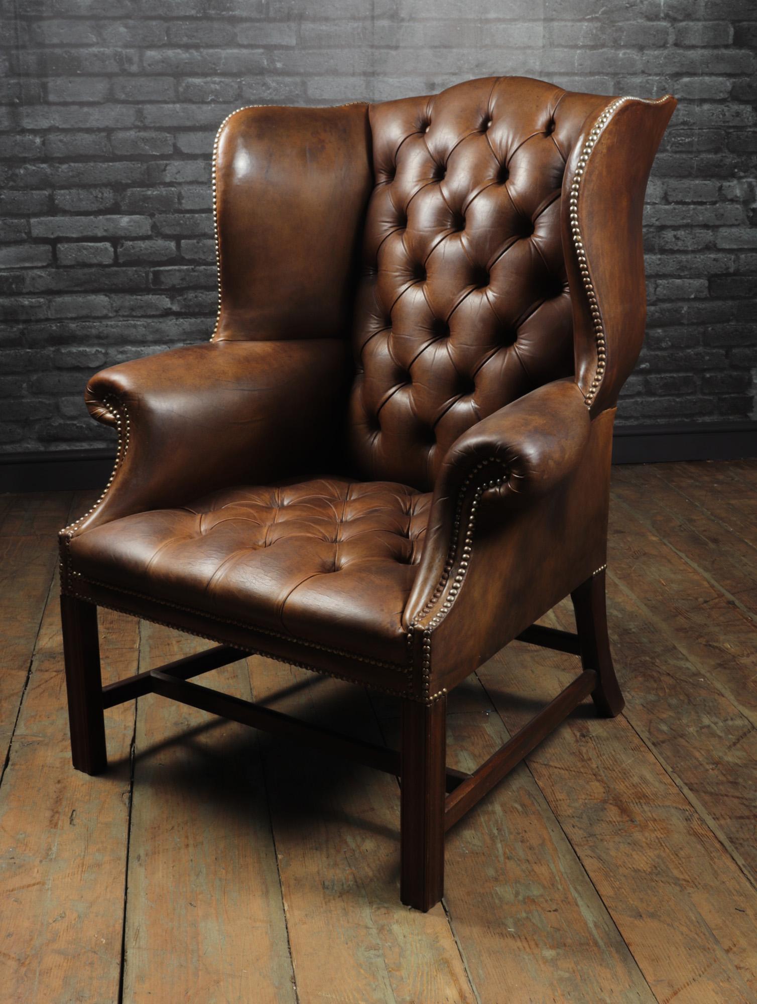 Georgian style brown buttoned leather wing chair
A deep buttoned sprung seat and back thick hyde leather then hand dyed in chestnut brown with brass studded detail. Produced in England around 1960, made in the Georgian period style and of very high