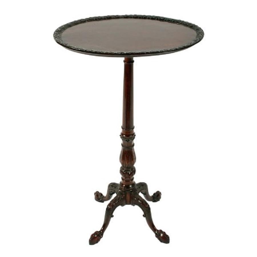 An early 20th century George III style mahogany candle stand.

The table has an oval tray shaped top with an acanthus carved edge and a slender turned and carved stem.

The base of the stem is highly decorated with a writhen carved ball and