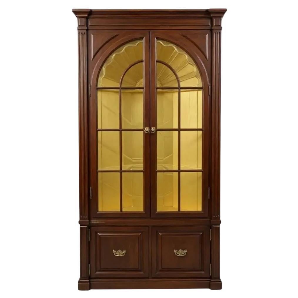 This is such a pretty piece! It is a George III style  carved mahogany corner cabinet with glass panel doors and vivid yellow interior. The highlight of the interior is the carved shell, which was actually thought to be a fan. It is unmarked and in