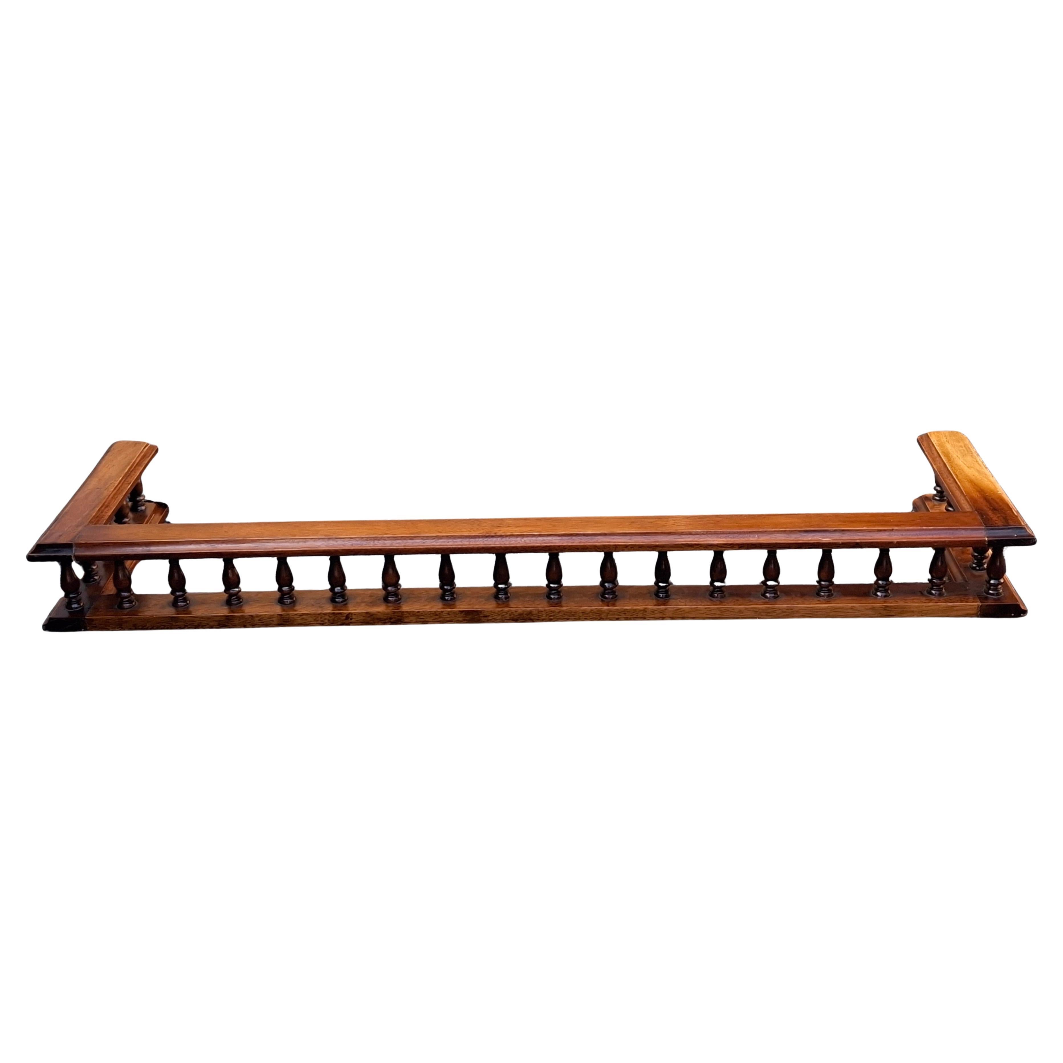 A Mid 20th Century Georgian Style Carved and Gallerried Mahogany Fireplace Fender.
Dimensions:  41.5