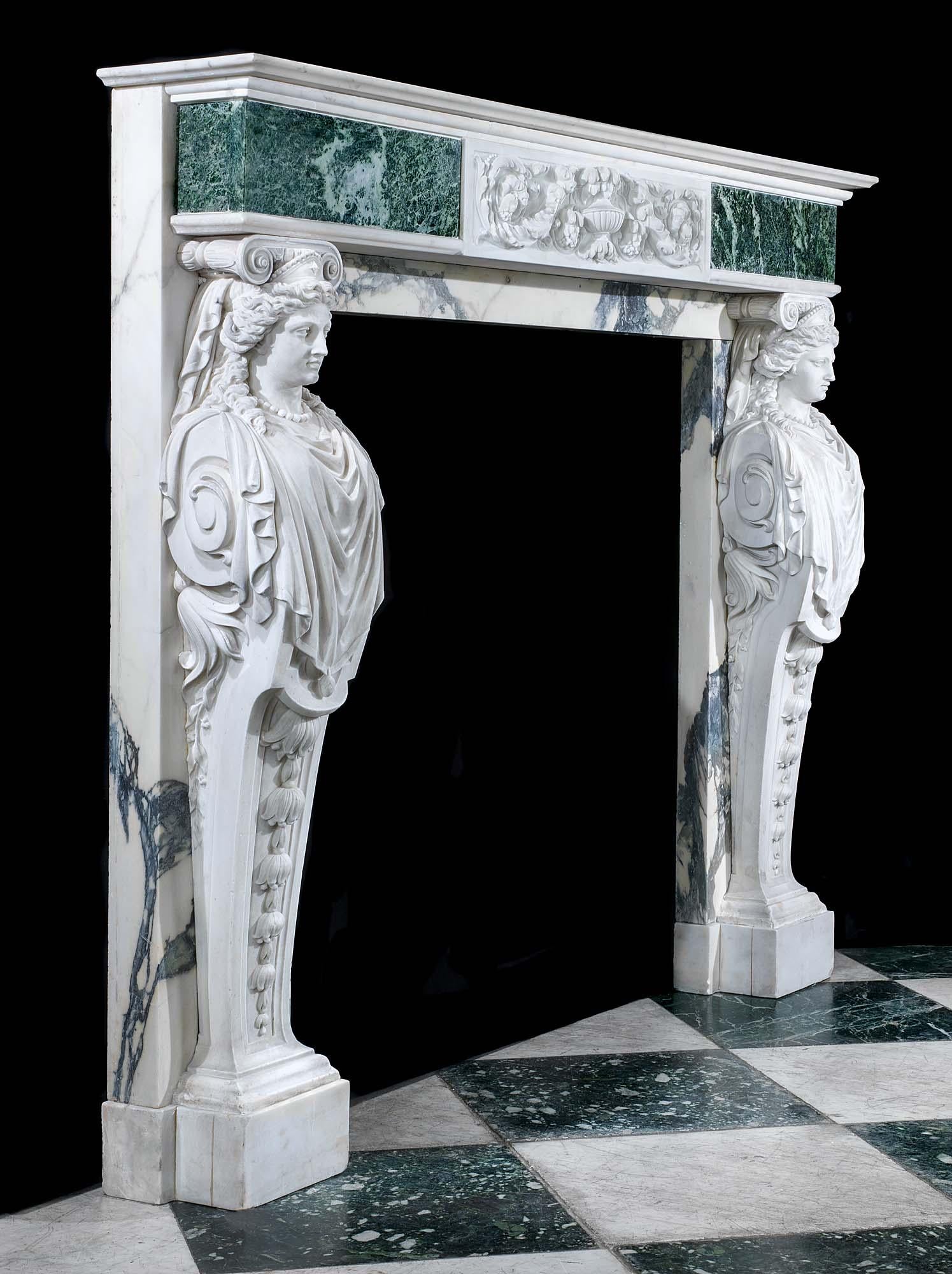 An early Georgian style white statuary marble fire surround with a verde antico marble frieze and breccia verde seravezza slips and jambs. The frieze, beneath a moulded shelf, is mounted with a central plaque of stylized urn, bellflowers and