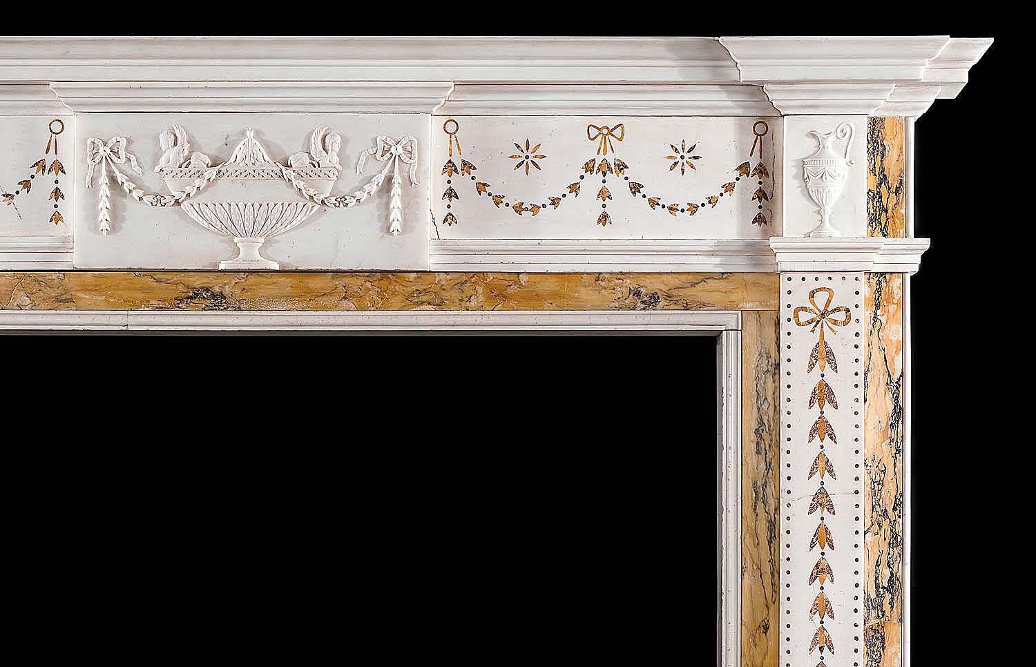 An elegant 20th century Georgian style chimneypiece in statuary and inlaid sienna
and brocatelle marble. The frieze beneath the breakfront shelf embellished
with inlaid sienna festoons and centred by a tablet of a lidded urn surmounted by
a pair