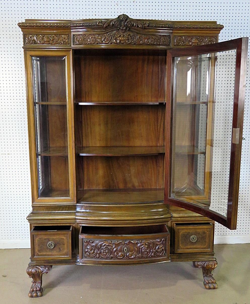 Georgian style inlaid china cabinet with beveled glass door containing 2 shelves over 3 drawers and bronze accents.
