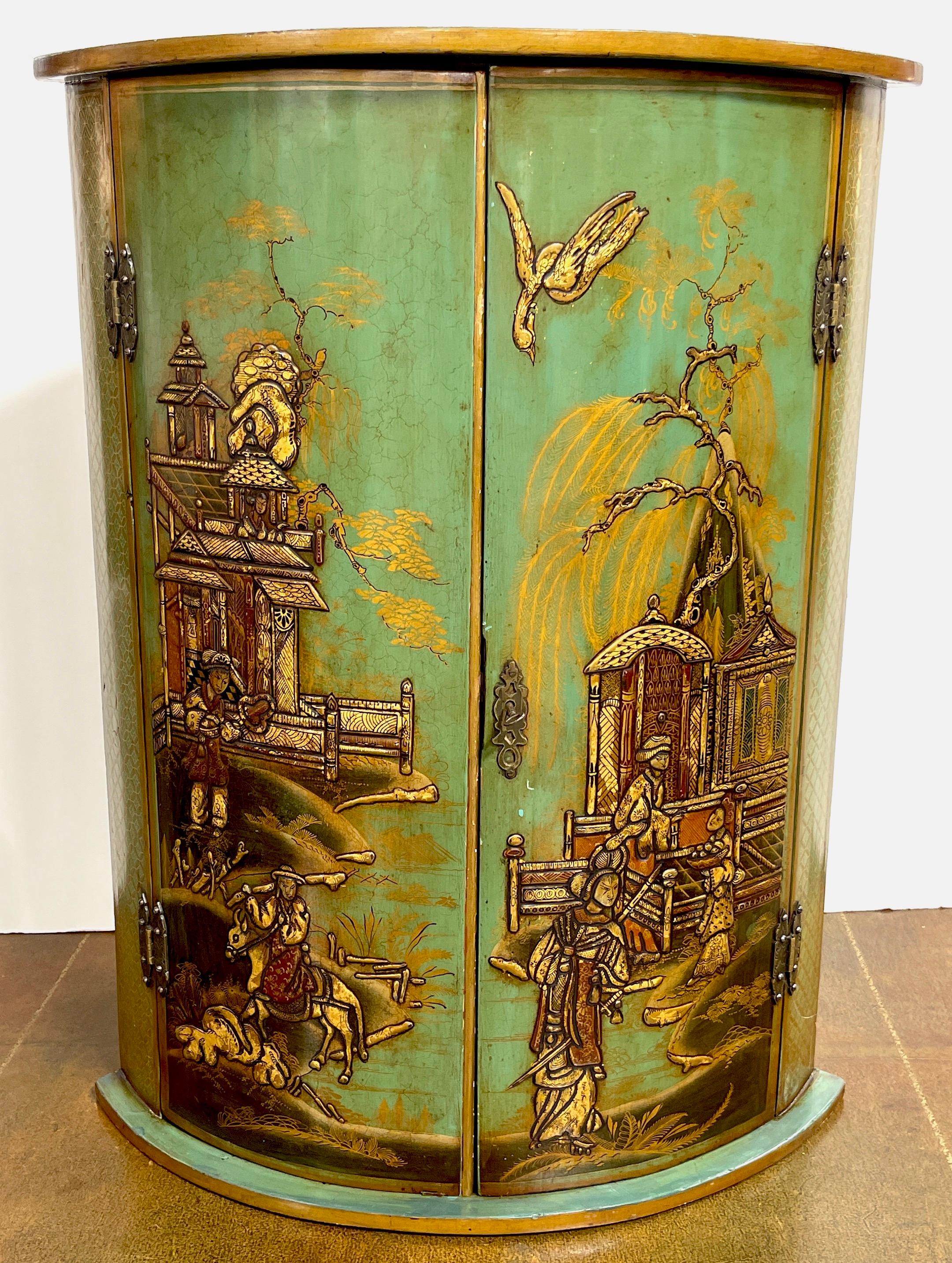 Georgian style Chinoiserie olive-green Lacquered blind door corner cupboard 
England, Circa 1890s

A good example of late 19th century English Chinoiserie lacquer work in a medium olive tone. Fitted with twin locking rounded doors decorated with