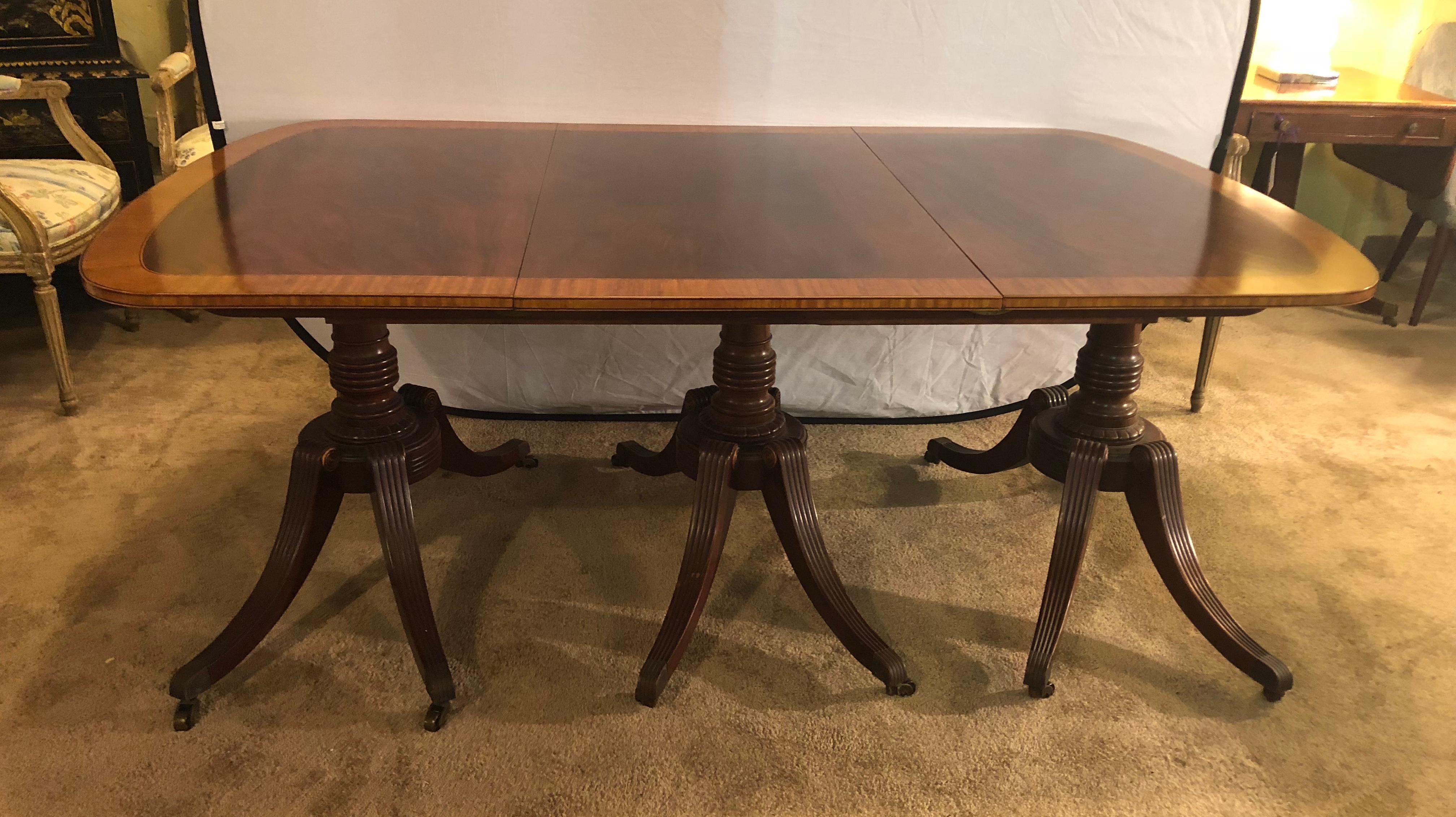 20th Century Georgian Style Crotch Mahogany Triple Pedestal Dining Table with Four Leaves