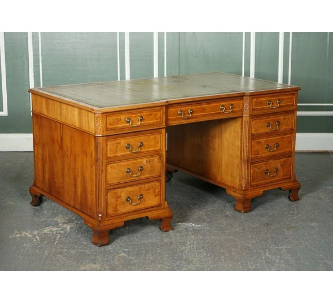 We are delighted to offer for sale this Lovely Yew Wood Georgian Style Directors Twin Pedestal Desk.

The desk still has the original aged inlaid green leather top with lovely golden embossing. Circa 1970s in the Georgian style. It still has its