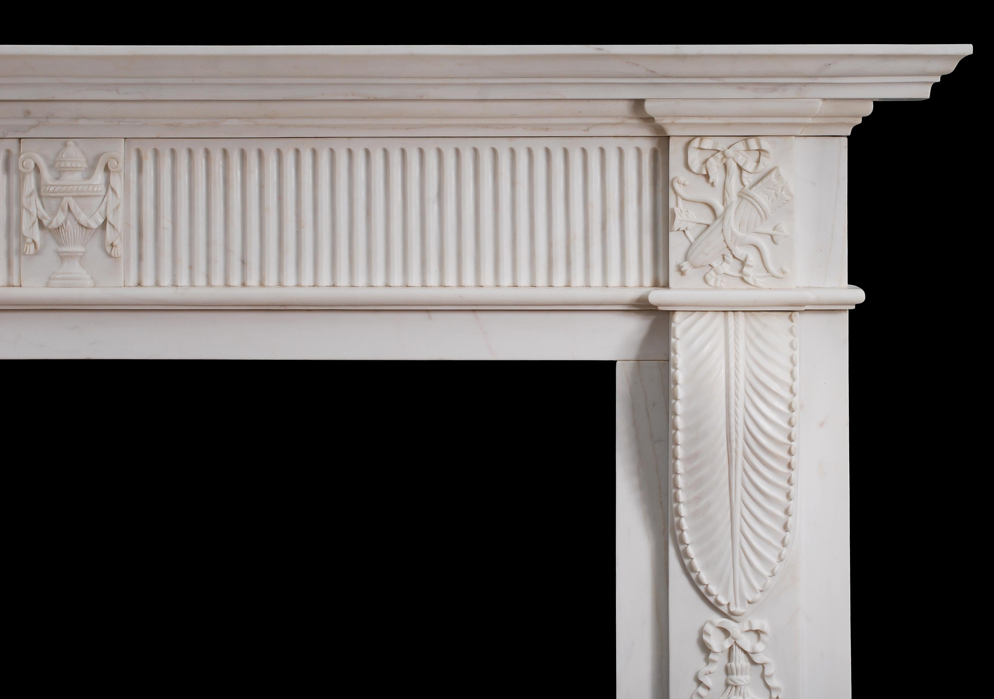 An English marble fireplace in pure white marble. The fluted frieze with carved urn to centre block and end blocks featuring quiver and swags. The jambs with shaped bracket and intricately carved foliage and drapery. Shaped, moulded