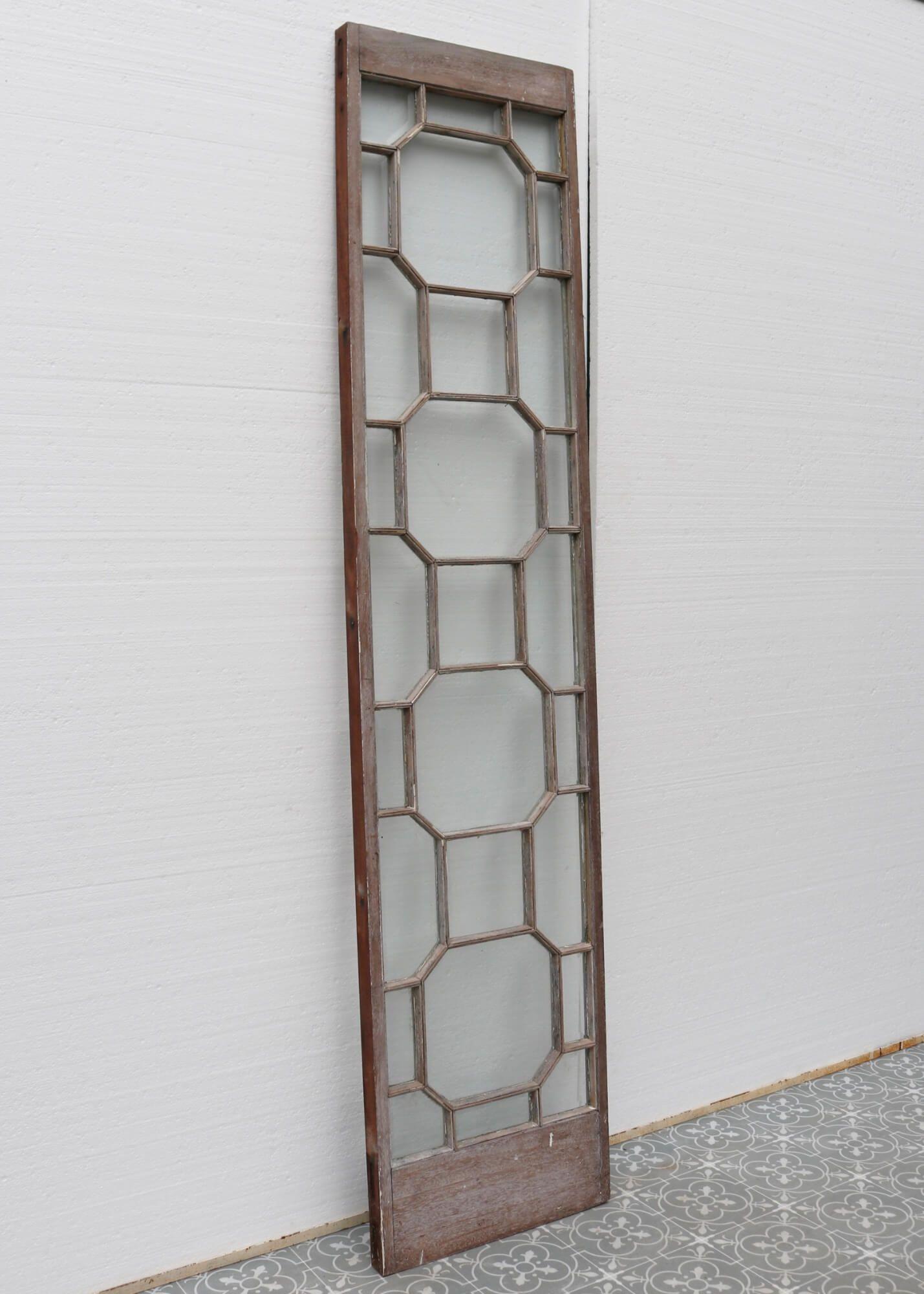 A classy and stylish mahogany and glass panel dating from the late 1880s. Though originating from the Victorian era, this handsome panel is a supremely stylish addition to a 21st century home with its impressive geometric design known as astral