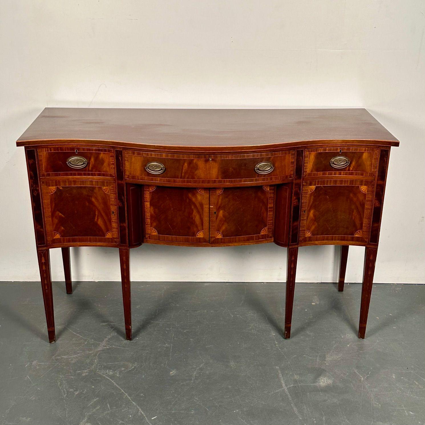Georgian Style Hepplewhite Mahogany Sideboard by Cabinetmaker W.J. Barry with original documentation

A serpentine front flame mahogany and satinwood inlaid sideboard circa 1930 in its original condition. All the bells and whistles on this
