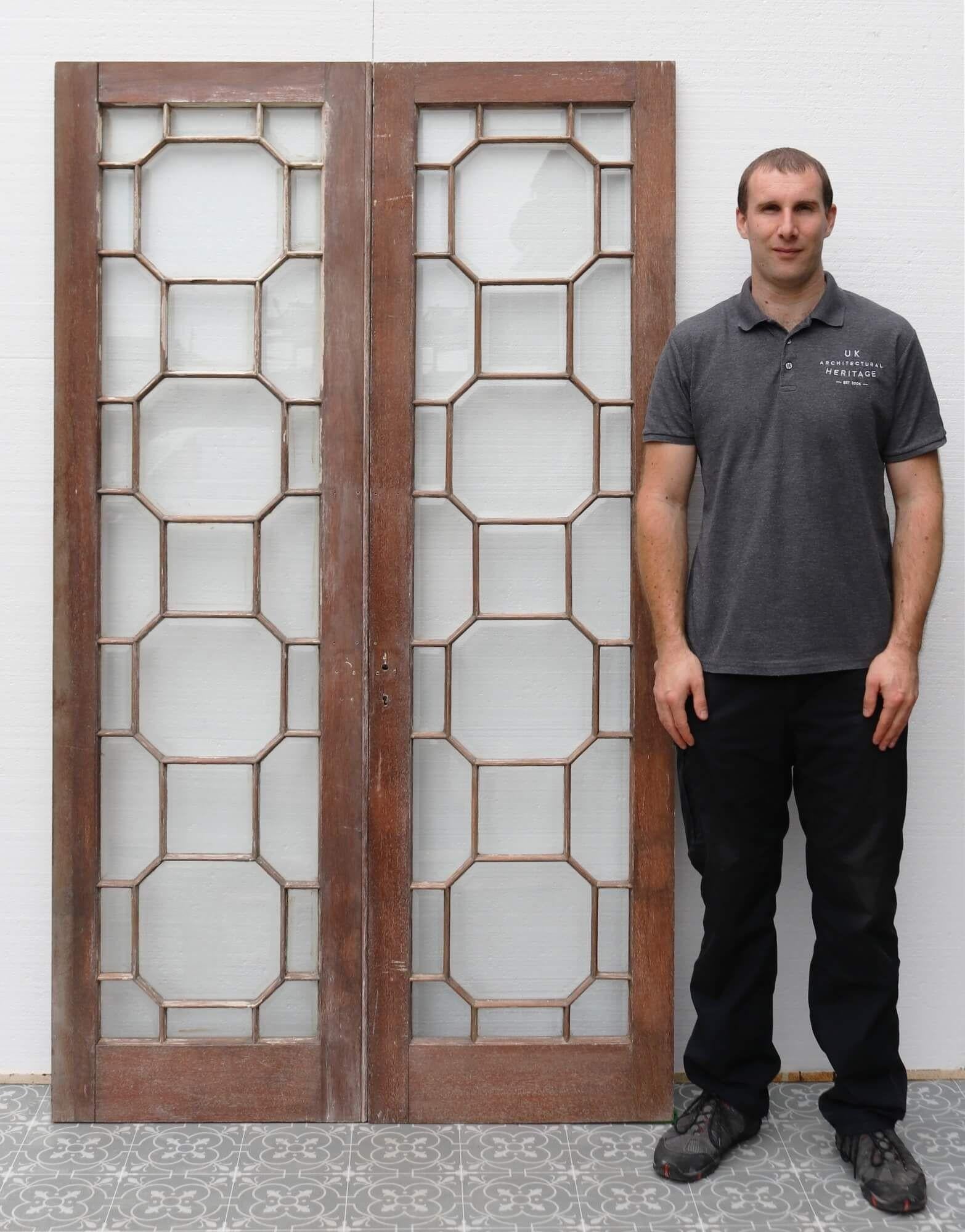 Though these Georgian style glazed internal double doors originate from the late 1880s, they are a supremely stylish addition to a 21st century home with their impressive geometric glazing. A solid mahogany frame surrounds a series of bevelled clear