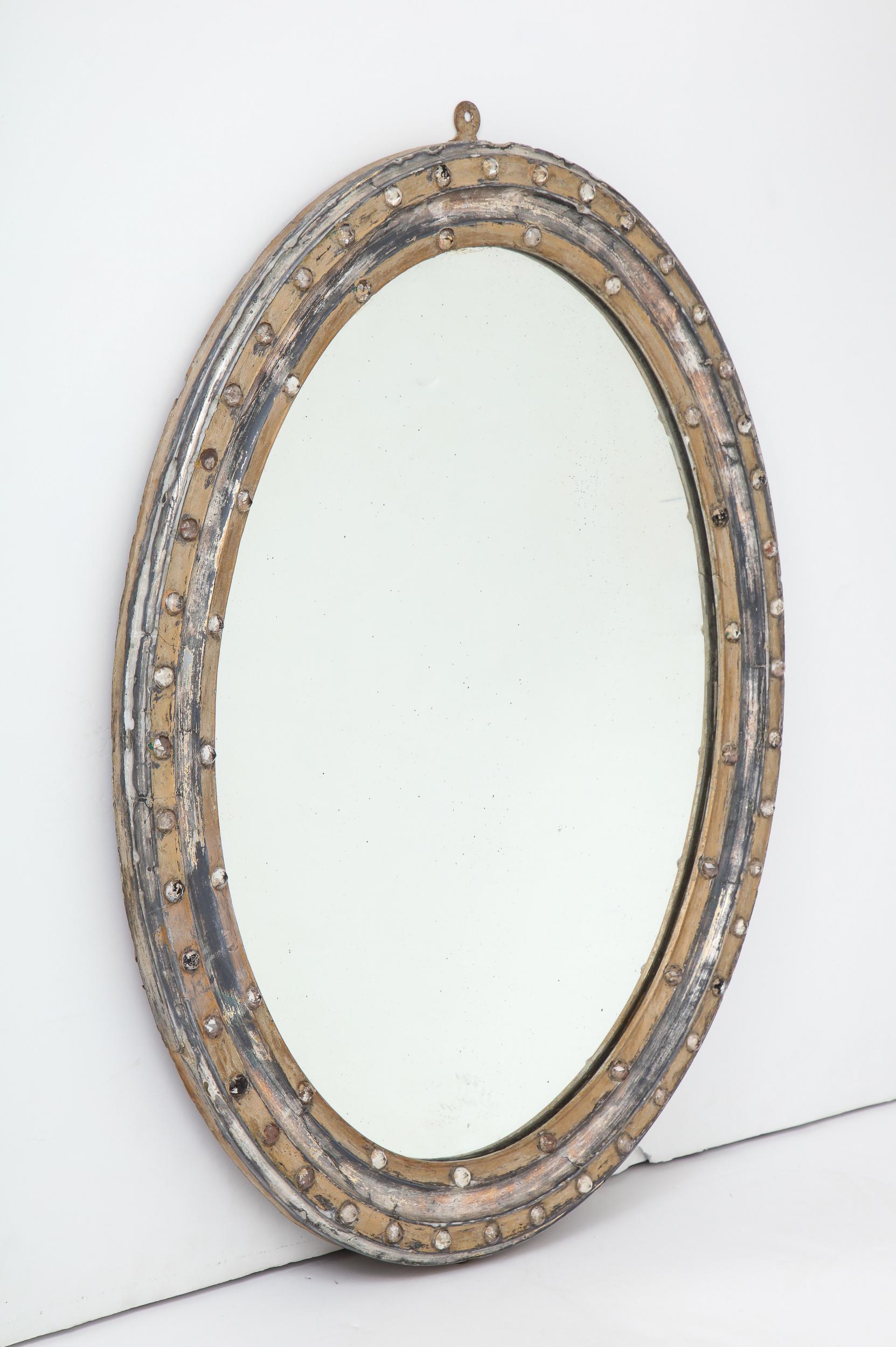 Antique Georgian style round wall mirror with silver gilt frame made in Ireland circa early 1800s. Mirror features a circular, double border frame encrusted with rock crystals. These nice details are accentuated by the patina on the frame. Original