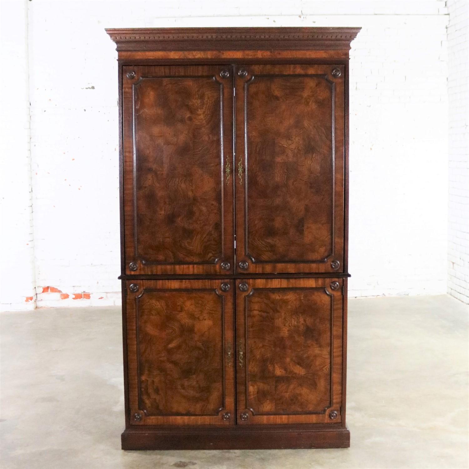 Handsome and stately large mahogany veneered entertainment armoire or wardrobe cabinet by Hekman Comfortable Living Furniture. This piece is in wonderful vintage condition but not without signs of use. There are nicks and dings that we feel only add
