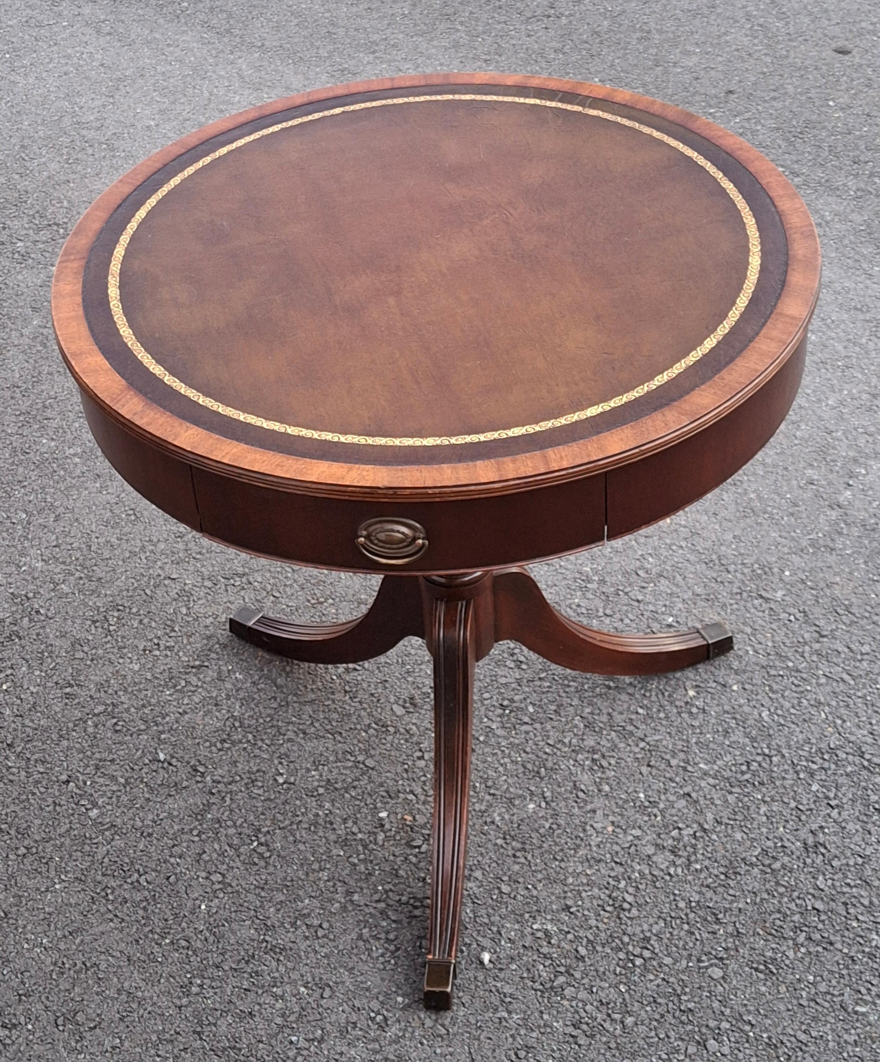 Georgian Style Mahogany and Tooled Leather and Stenciled Top inset Drum Center Table Circa 1930s.
Measures: 30