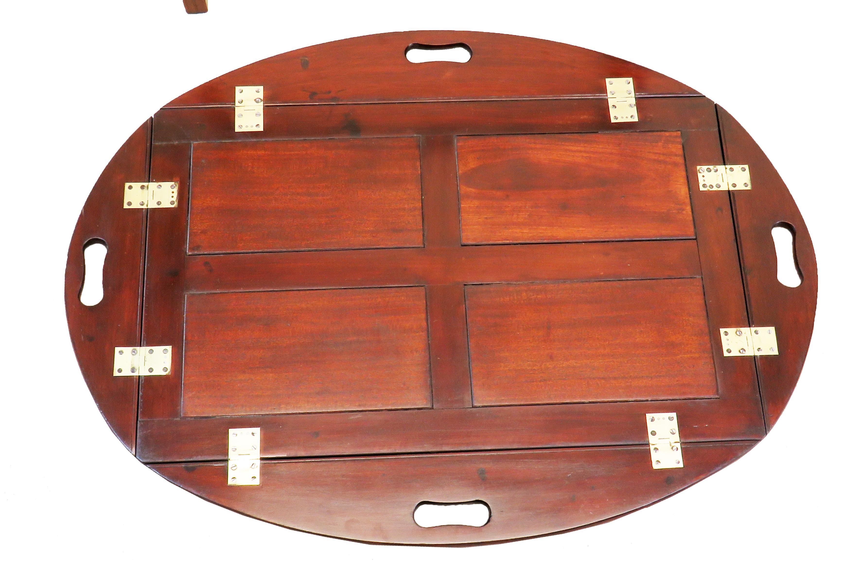 A good quality early 20th century mahogany oval
Butlers tray in the Georgian style having panelled
Construction and original brass hinges to folding
Sides raised on later square tapered leg stand

(Always a good answer to the age old problem of