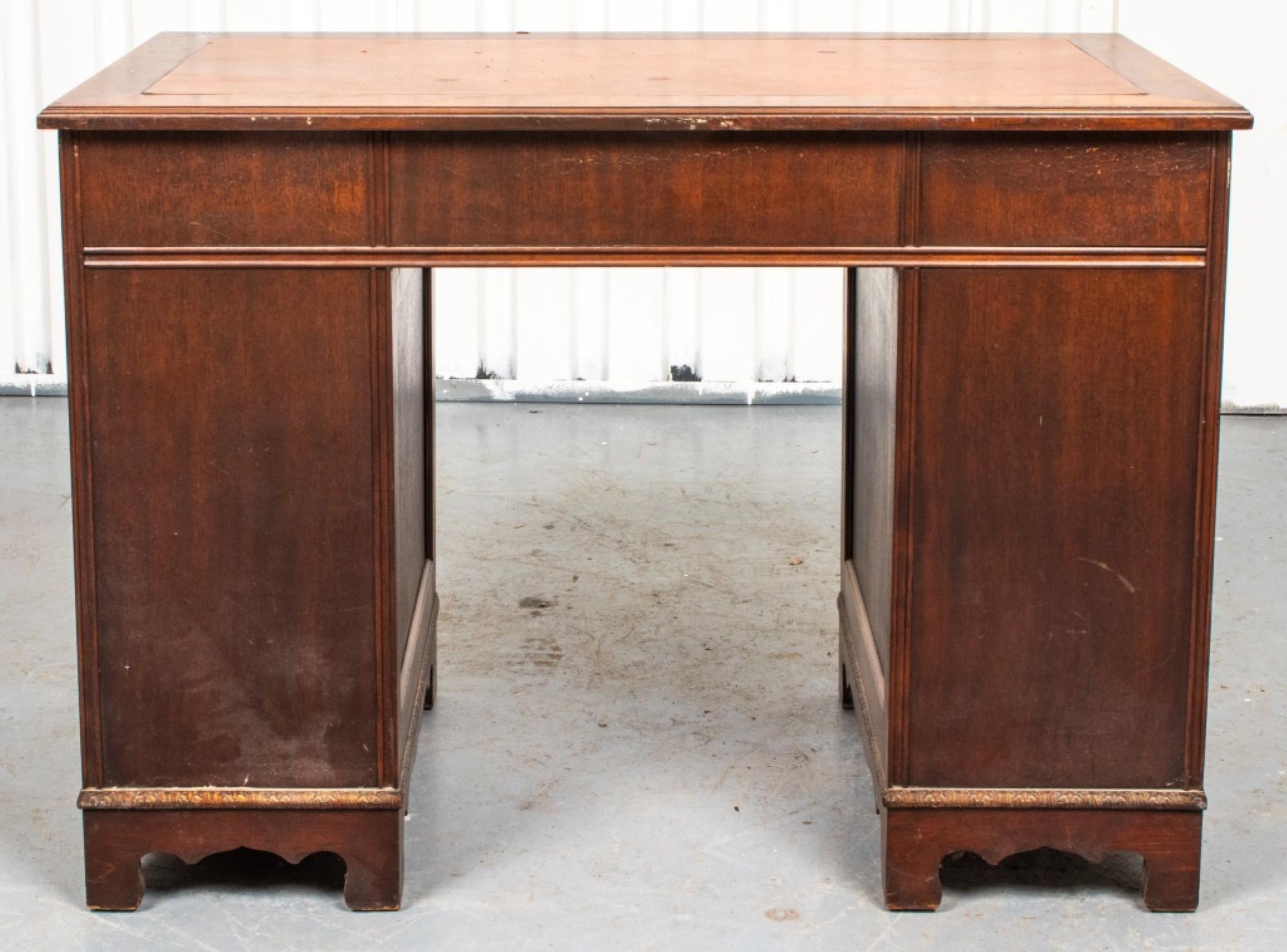Georgian style mahogany pedestal desk with inset leather top and nine drawers raised on ogee bracket feet.

Dealer: S138XX