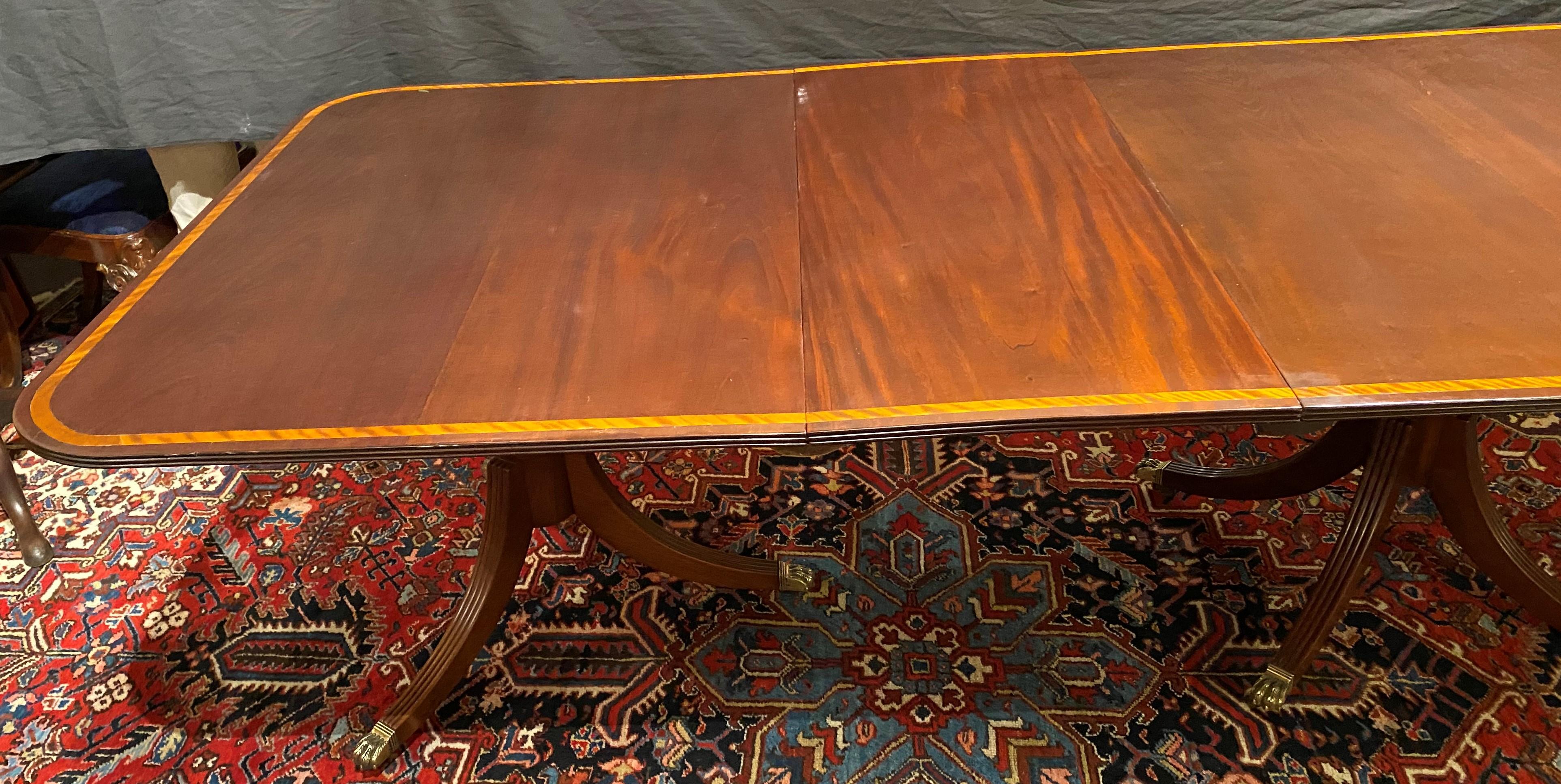 English Georgian Style Mahogany Triple Pedestal Banded Dining Table with Two Leaves