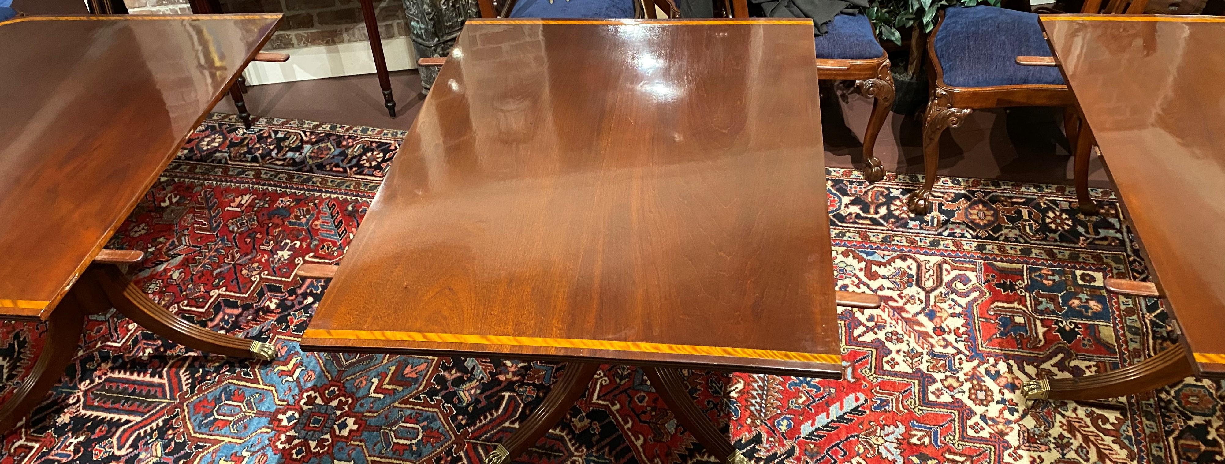 20th Century Georgian Style Mahogany Triple Pedestal Banded Dining Table with Two Leaves