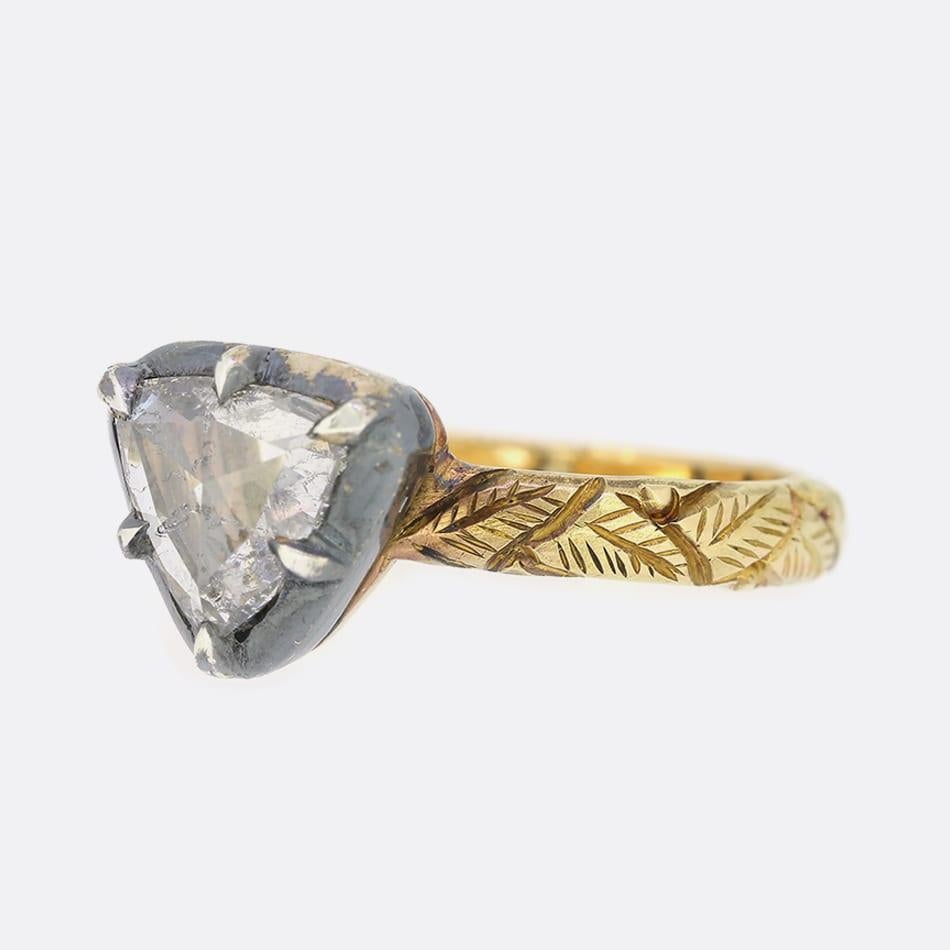 This is a beautiful, 18ct yellow gold, rose cut diamond ring. The ring is in a Georgian style and the band features wonderful foliate detail. Although the band is 18ct yellow gold the diamond is set in oxidised silver to emphasise its sparkle.

This