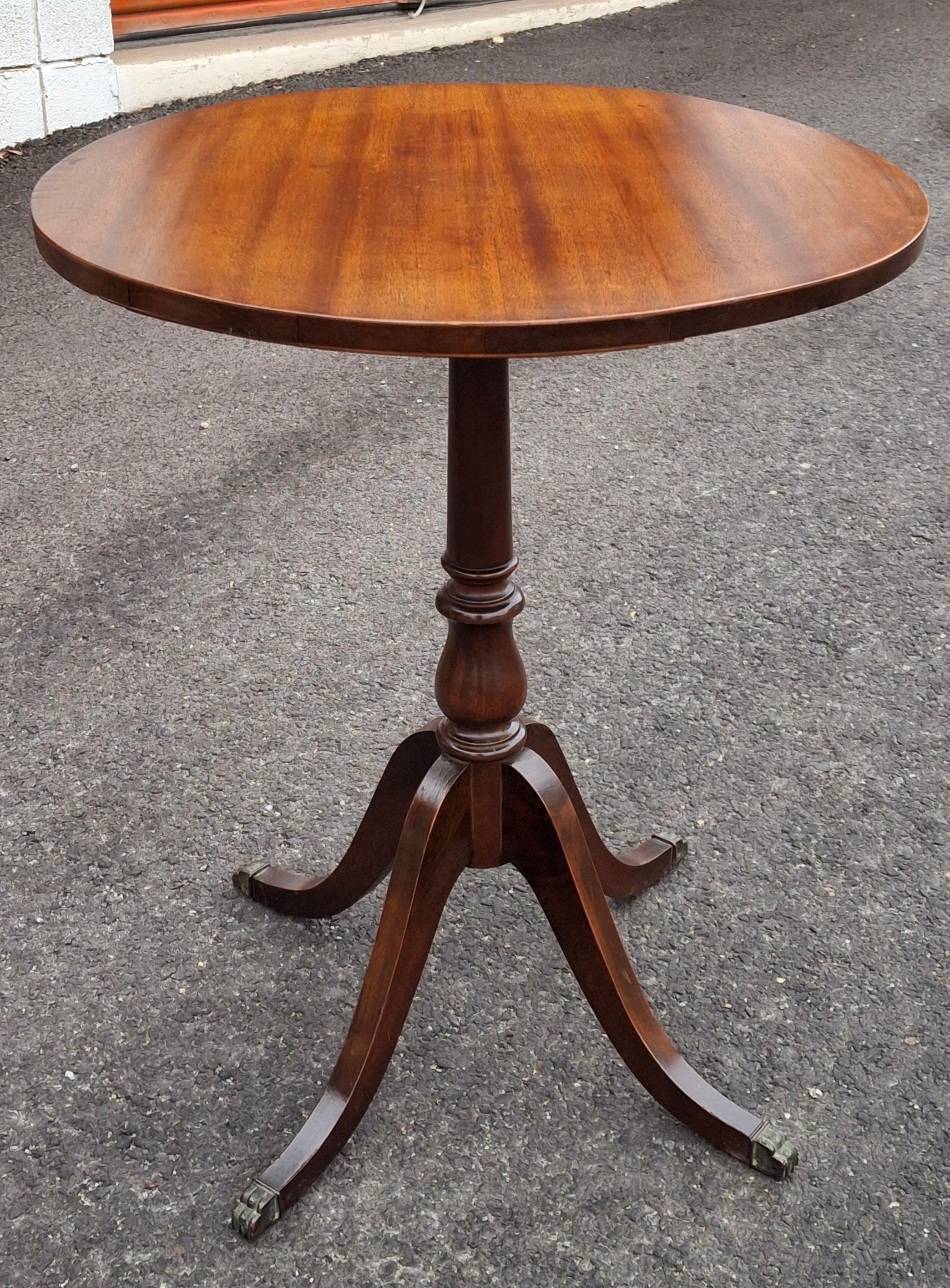 An Early 20th Century George III satin Mahogany pedestal quadpod terminating with brass paw feet in very good antique condition. 
Measures 22