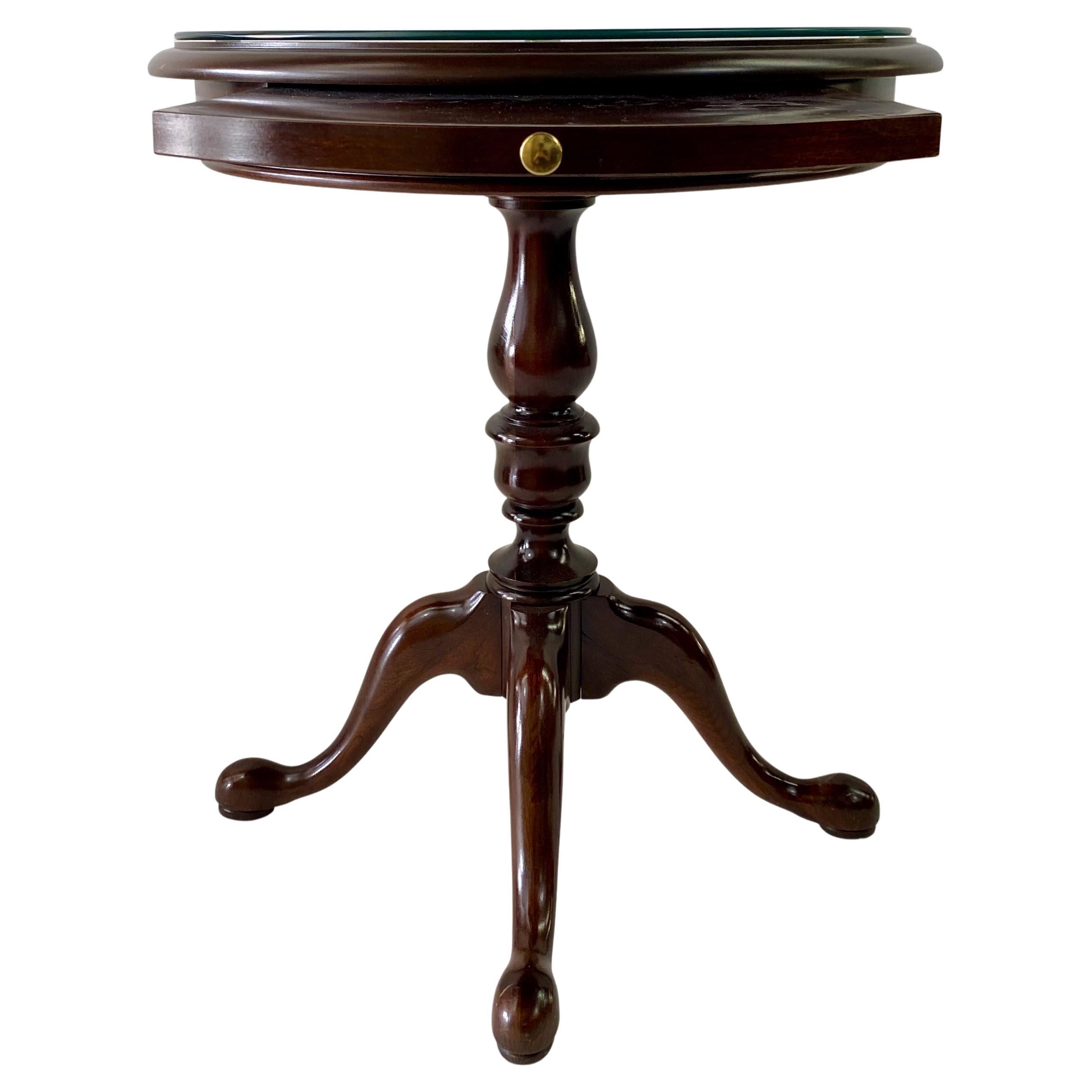 A quality and classy gueridon table made of fine Mahogany wood. The side or end table oval shaped top features beautiful natural wood grain and is equipped with a pull extension tray offering more space to place additional items. The base and the
