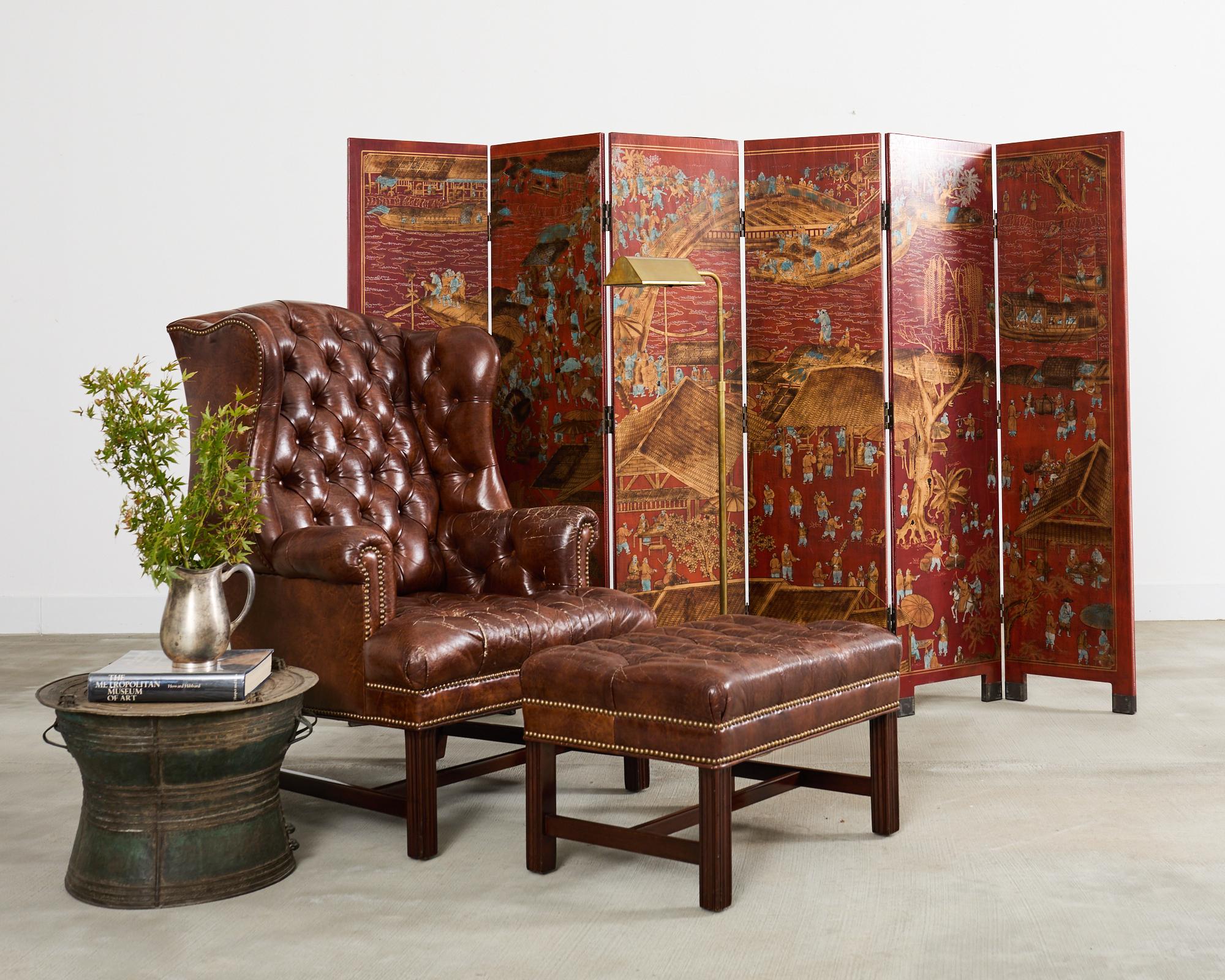 Sillón georgiano de respaldo alto con mechón, bellamente envejecido, y otomana a juego, fabricados por Schafer Bros. El sillón grande tiene un armazón de madera dura de caoba con alas totalmente desarrolladas y un asiento generoso. El armazón se ha