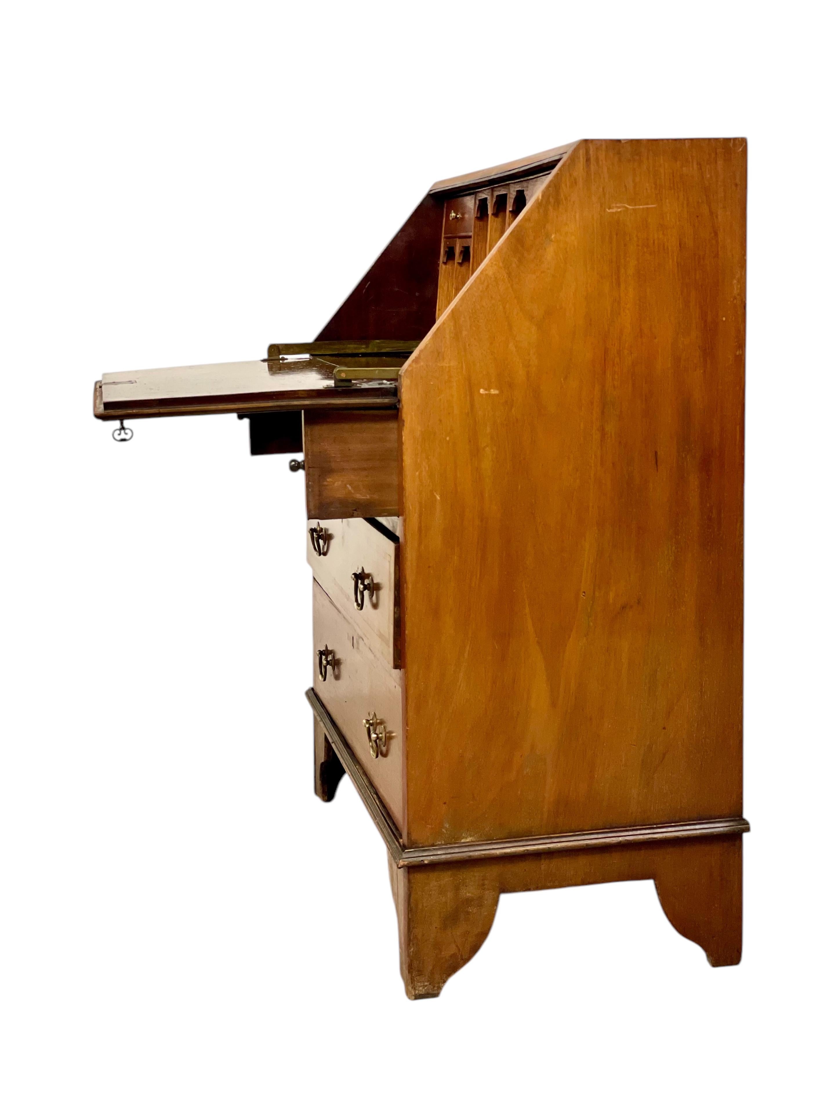 This elegant fall-front bureau is a beautiful example of late 18th-century English craftsmanship in the Georgian style, dating circa 1780–1800. Traditionally made in mahogany, this particular piece is crafted in walnut — a noble and durable wood