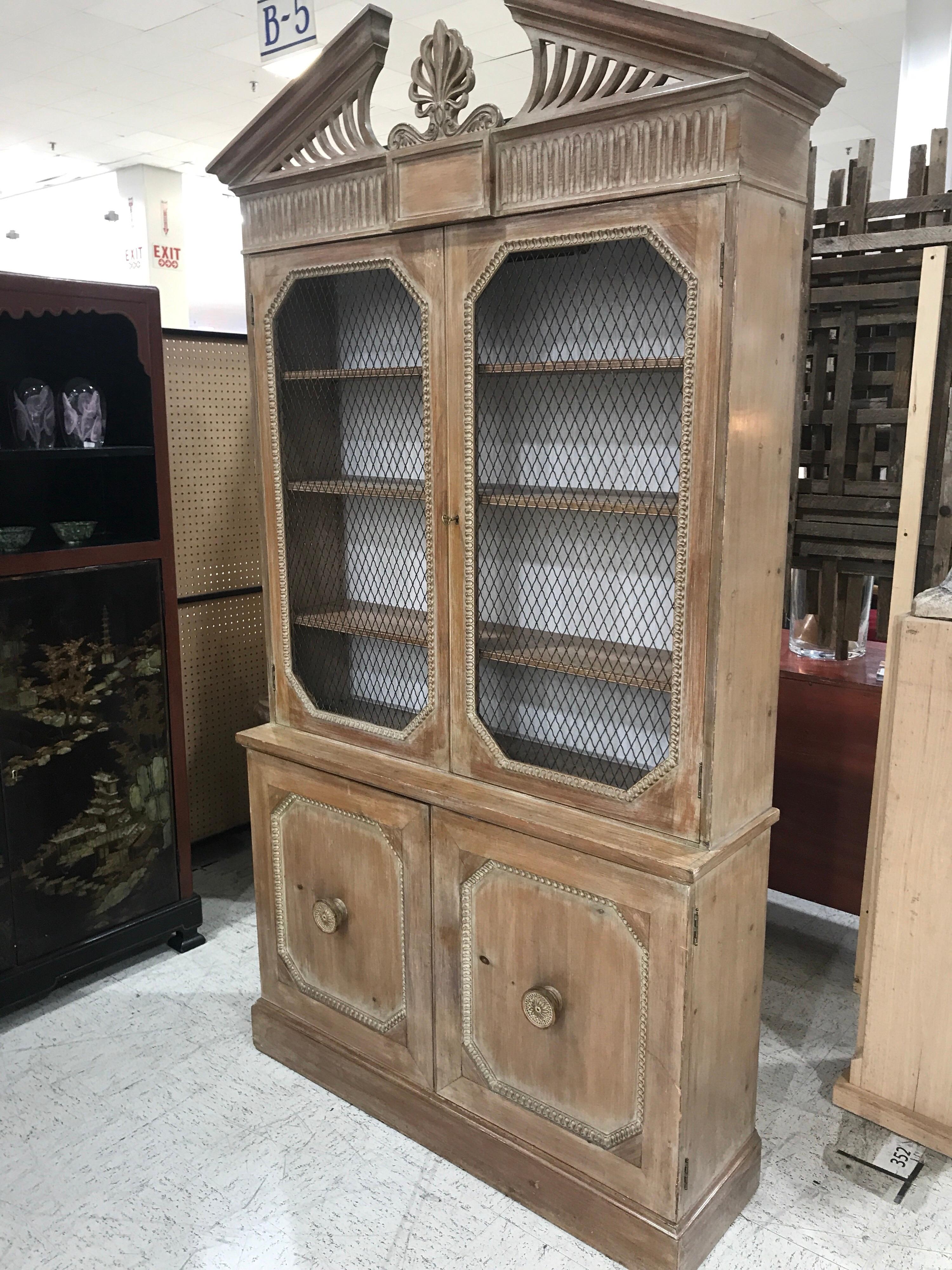 Georgian style white washed pine bookcase or breakfront, of diminutive proportions, with carved broken arch top, over a case fitted with two wire mesh doors, with lighted interior with four 9