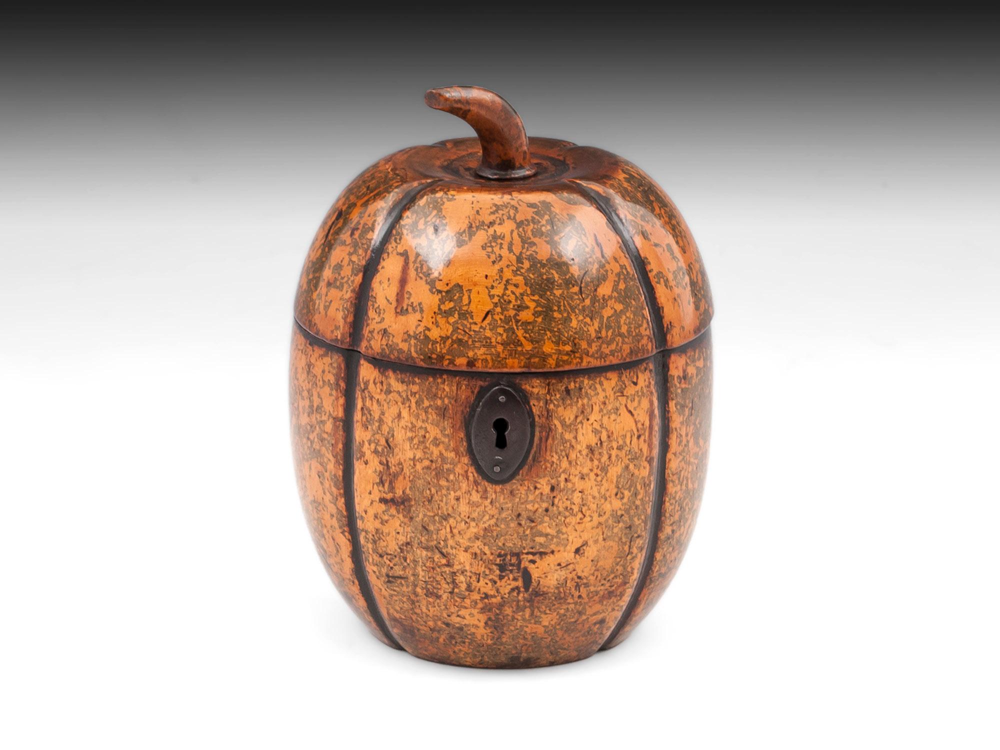 Melon tea caddy with a fantastic green and brown mottled decoration and featuring a shaped wooden stalk, steel lock, hinge and oval escutcheon.
The interior still has traces of the original tin lining, has a working lock & tasselled key.

This