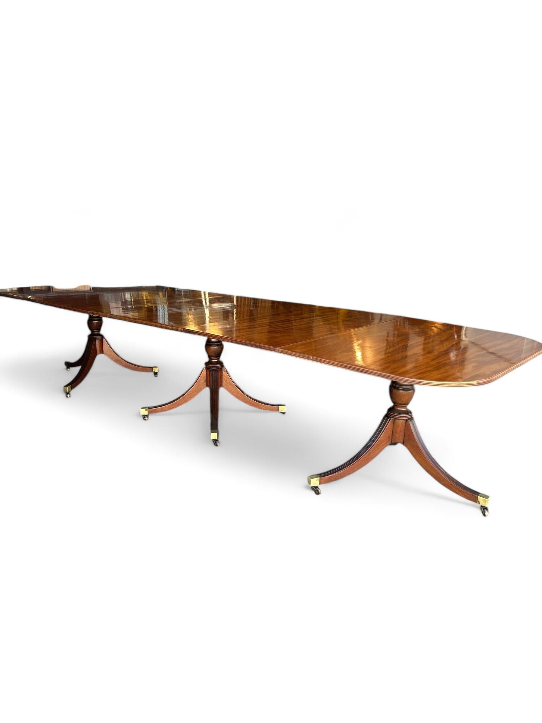 Introducing a stunning solid mahogany dining table, a timeless piece crafted in the early 1900s that exudes elegance and functionality. Designed with three sturdy pedestals, this table offers remarkable stability and ample space for gatherings.