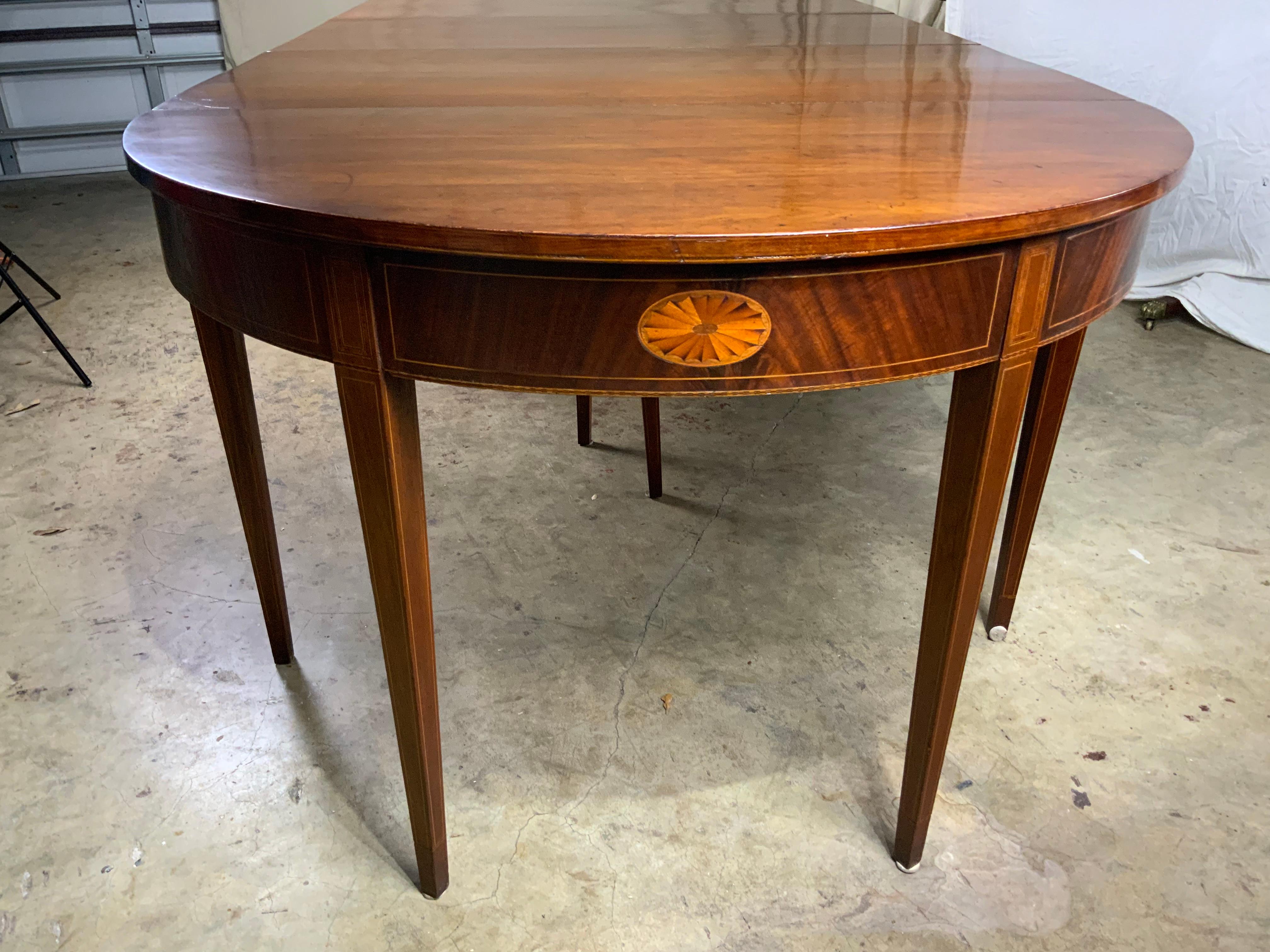 A very nice 12’5” large three section Hepplewhite style inlay Mahogany banquet dining table.  This table is completely all original and was specifically built to always be a large dining table with the two demilune ends having drop leaves and the