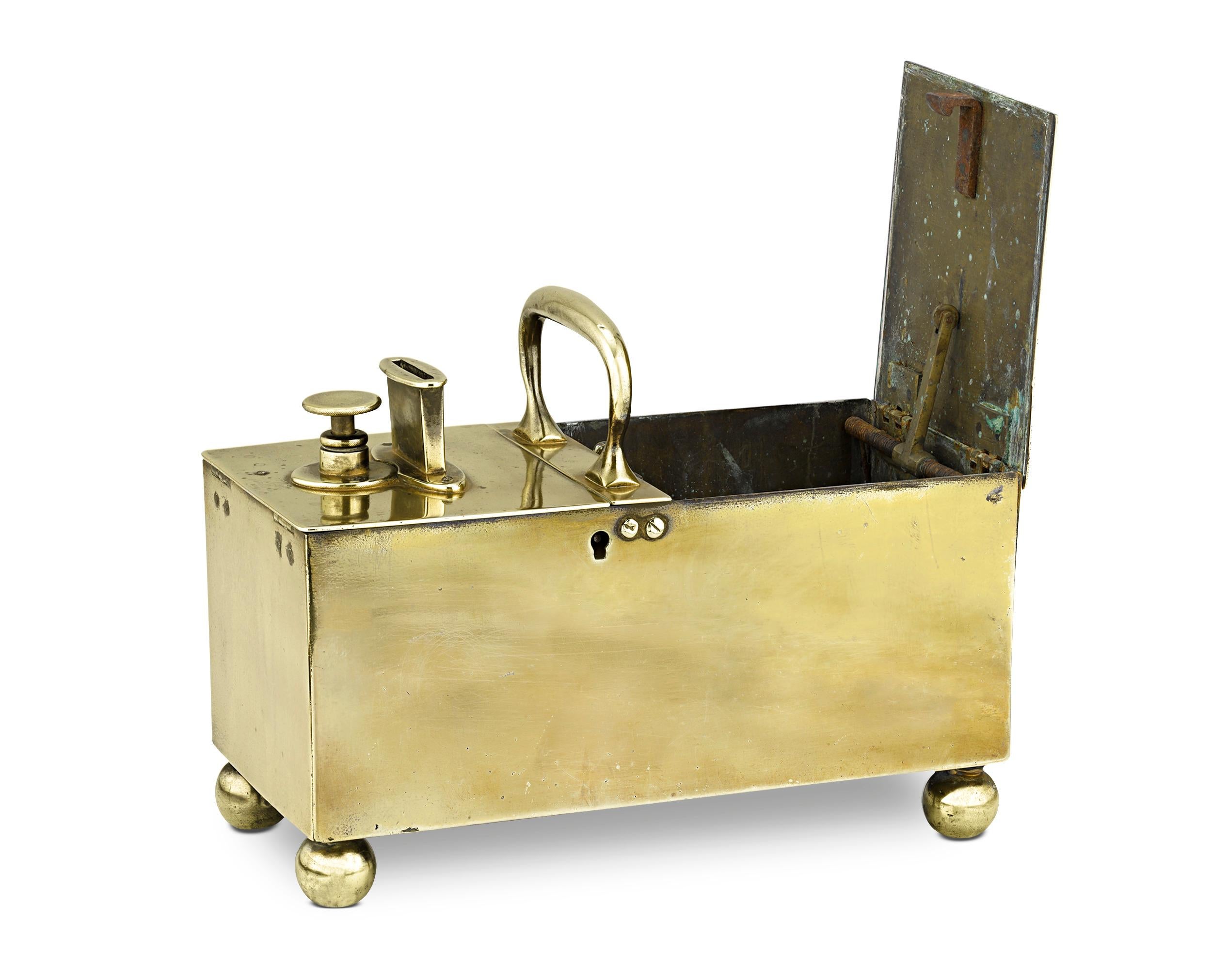 This rare brass box would have been a coveted contraption in the finest English pubs of the 18th and 19th centuries. Known as an “honesty” box, the rectangular brass box features a double-hinged lid and two compartments, one for coins and one for
