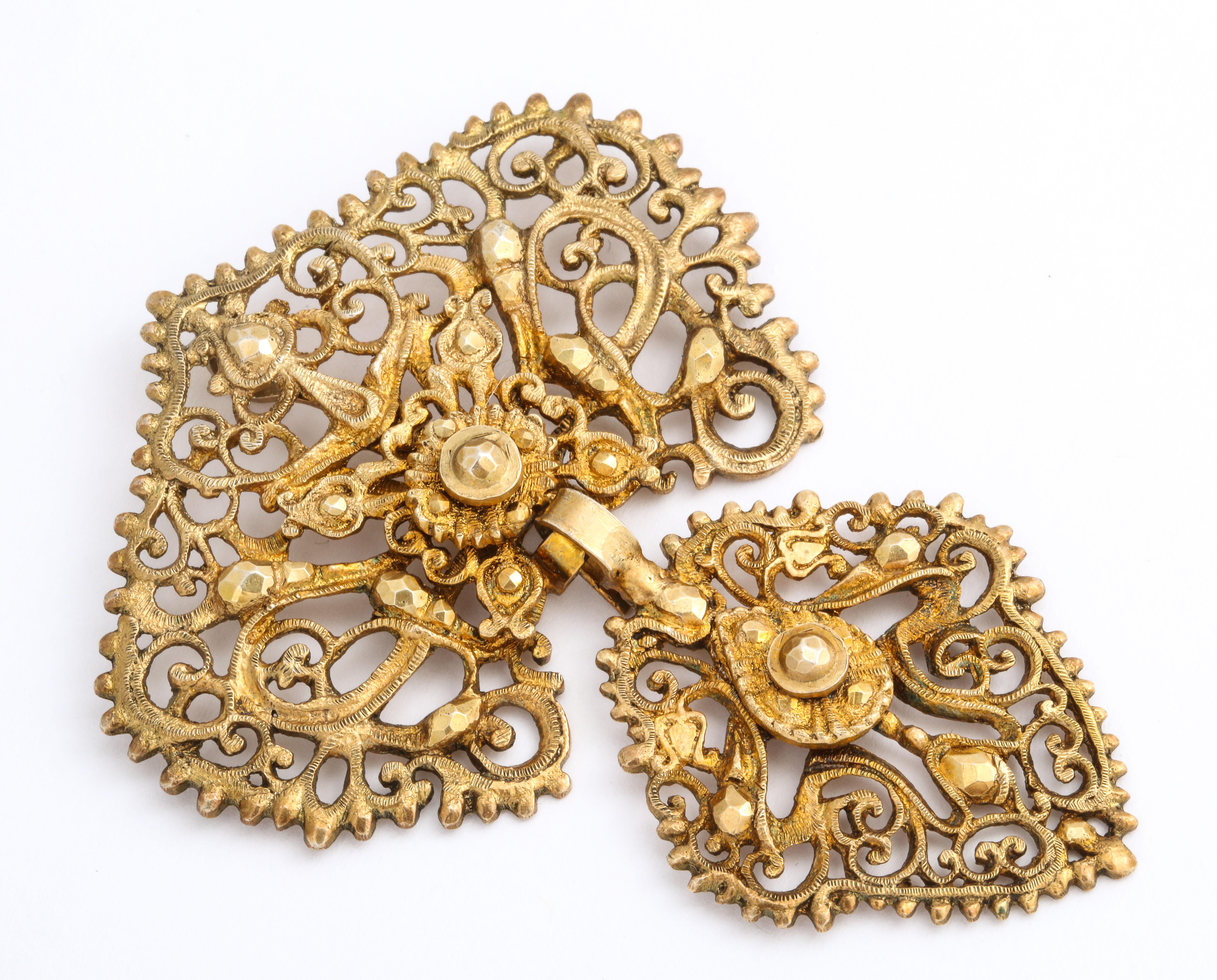 Proving that all beautiful jewelry can be other than gold or silver, this Georgian pendant of lacy openwork in a floral vine motif mimics the real thing made c. 1800, yet this is gilded metal. Texture is all here with smooth and non smooth surfaces.